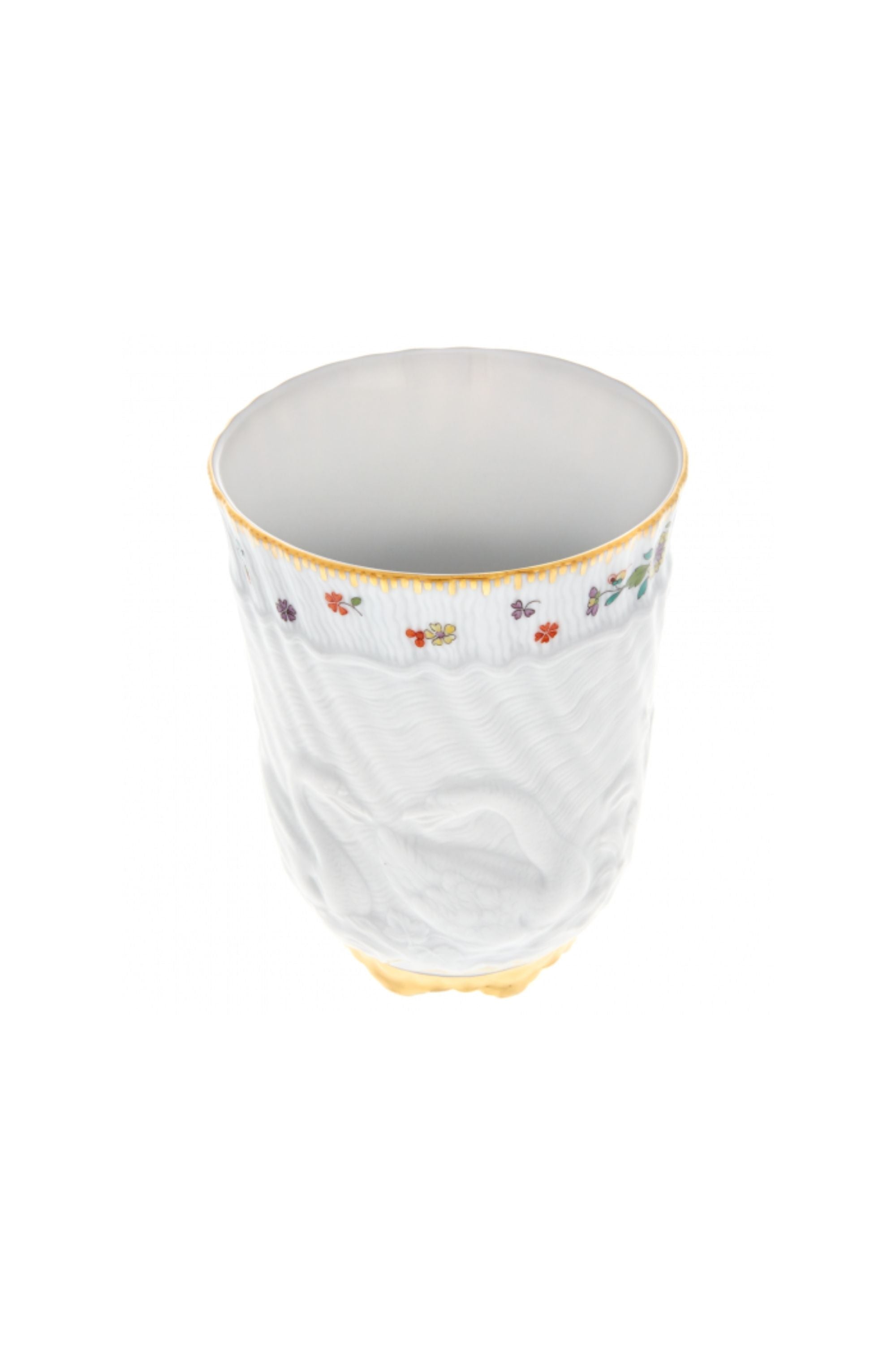 Beaker designed by Johann Joachim Kändler, the pattern features a delicate background with radiating bands based on a scallop shell and a central well dressed with a pair of swans on water amid bullrushes, swooping cranes, and fish. Several parts of the service depict figures from Greco-Roman mythology, like Glaucus and the dolphin-riding Galatea.