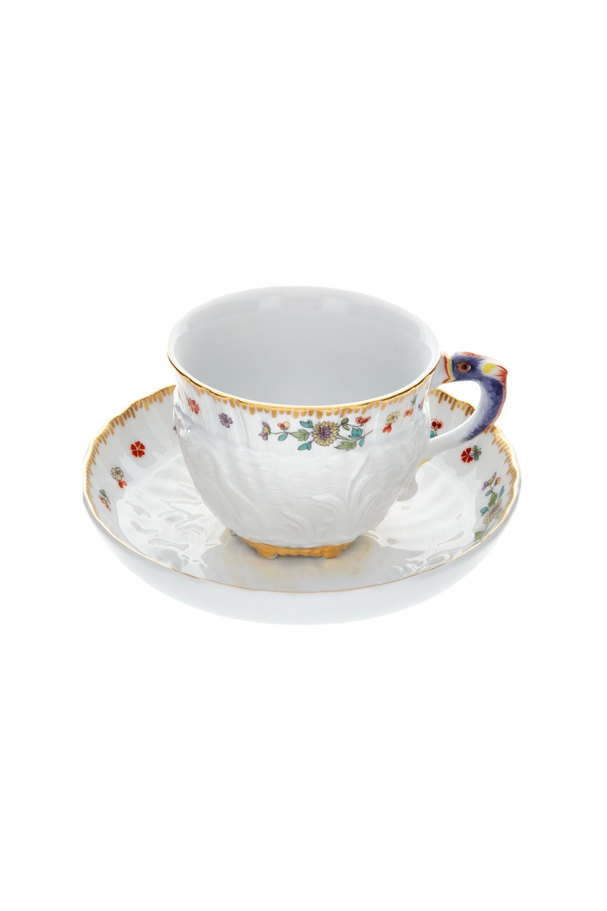 Designed by Johann Joachim Kändler, the pattern features a delicate background with radiating bands based on a scallop shell and a central well dressed with a pair of swans on water amid bullrushes, swooping cranes, and fish. Several parts of the service depict figures from Greco-Roman mythology, like Glaucus and the dolphin-riding Galatea.