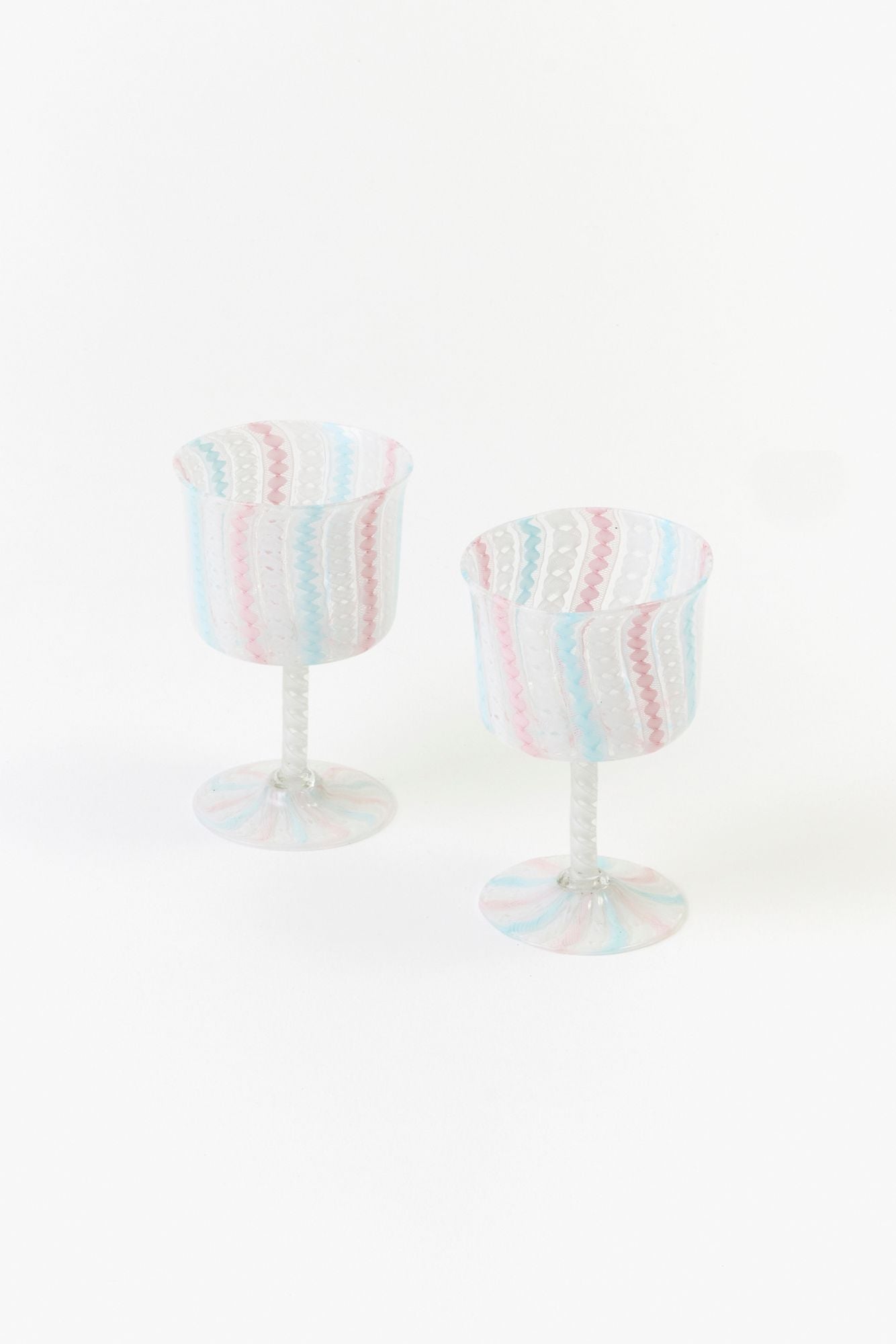 Two striped wine glasses on a white background