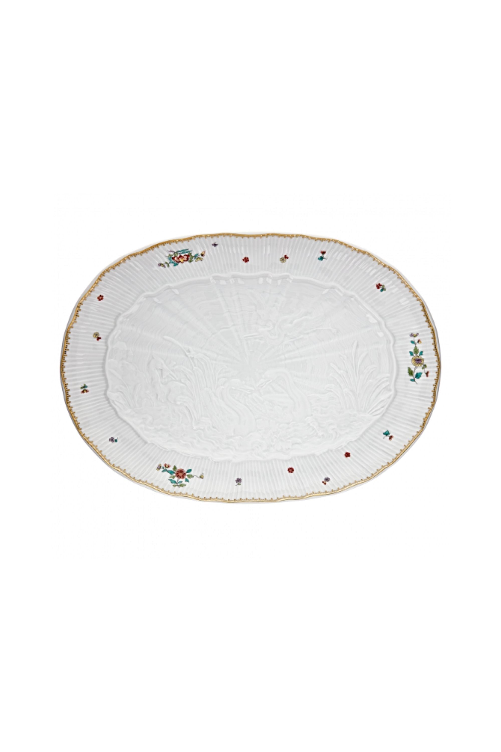 Oval platter designed by Johann Joachim Kändler, the pattern features a delicate background with radiating bands based on a scallop shell and a central well dressed with a pair of swans on water amid bullrushes, swooping cranes, and fish. Several parts of the service depict figures from Greco-Roman mythology, like Glaucus and the dolphin-riding Galatea.