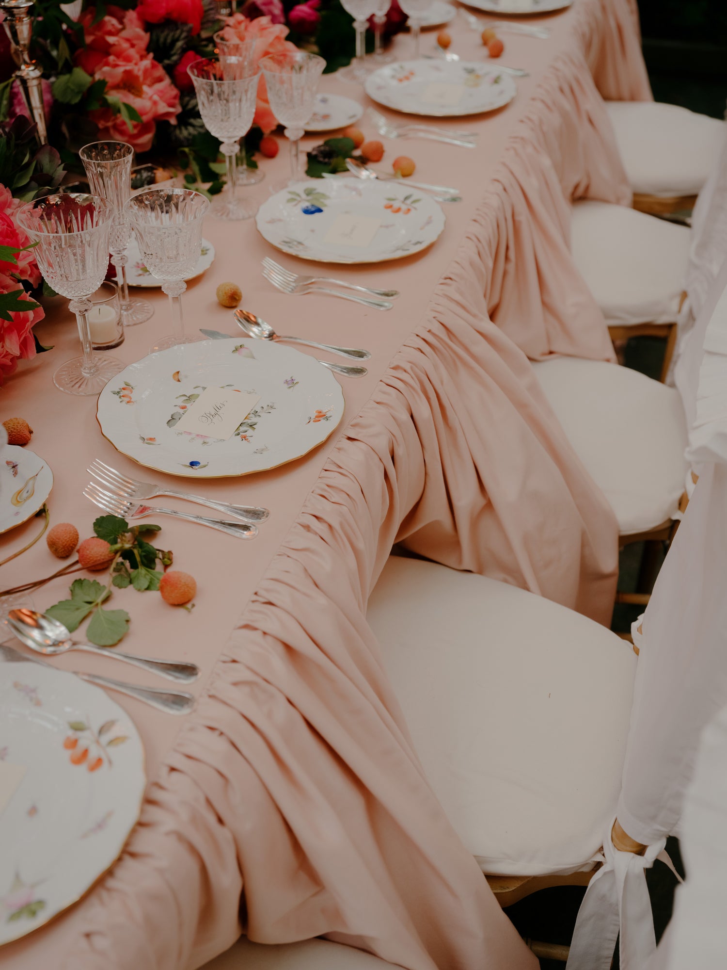 pink tablecloth with elegant china and glassware