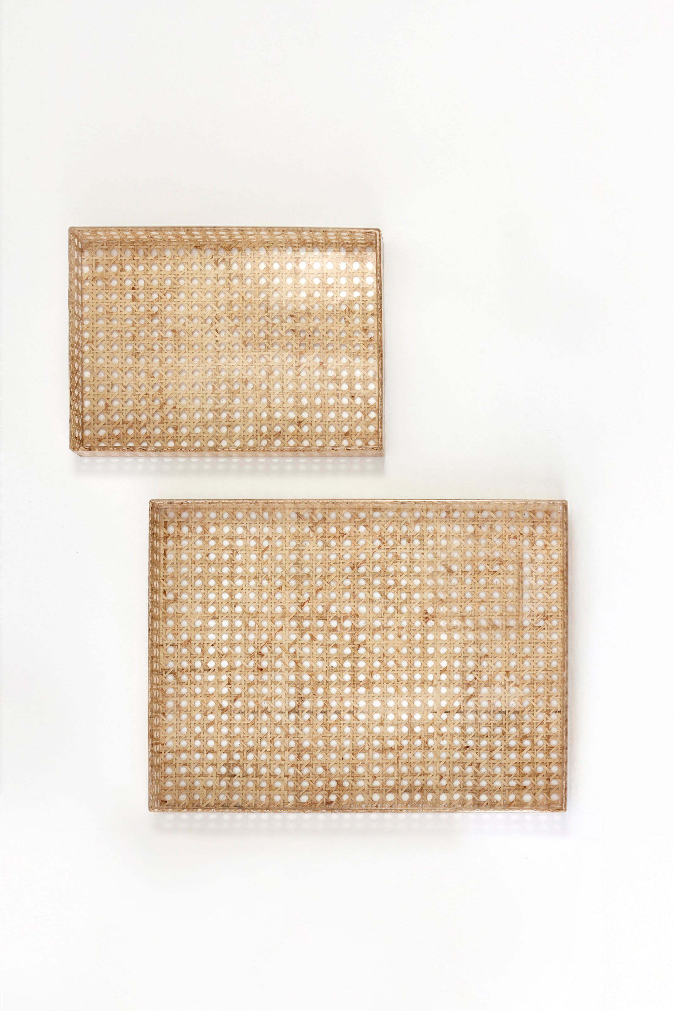Two cannage trays on white background