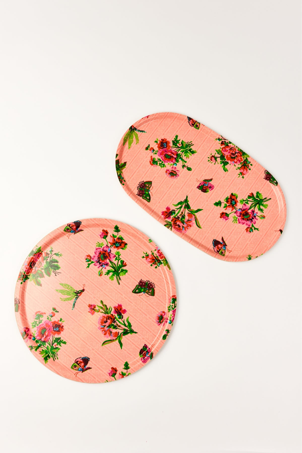 Two floral-patterned pink laminated trays with butterflies and flowers on a white background.