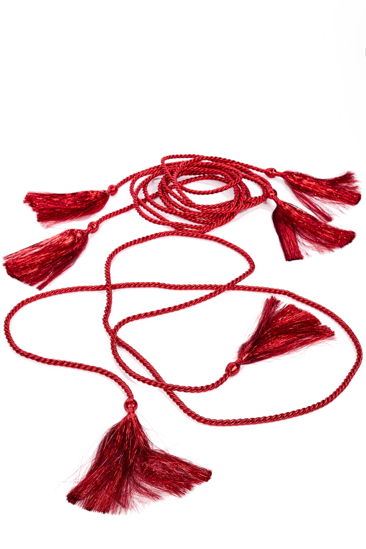 A red braided cord with multiple decorative tassels, laid out on a plain white background.