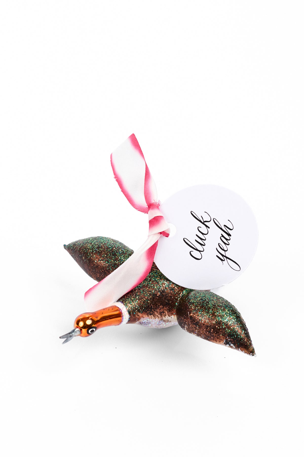 Ornament of a mallard with blue-green glitter and shiny orange head. Pink and white silk ribbon with a tag that says "duck yeah"