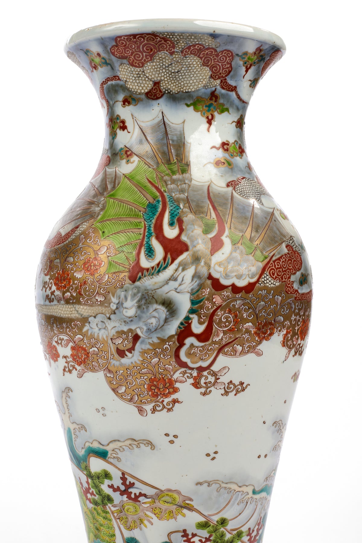 An antique Japanese white porcelain vase decorated with colorful hand-painted dragons, clouds, and waves in red, green, gold, and blue glazes, shown against a plain white background.