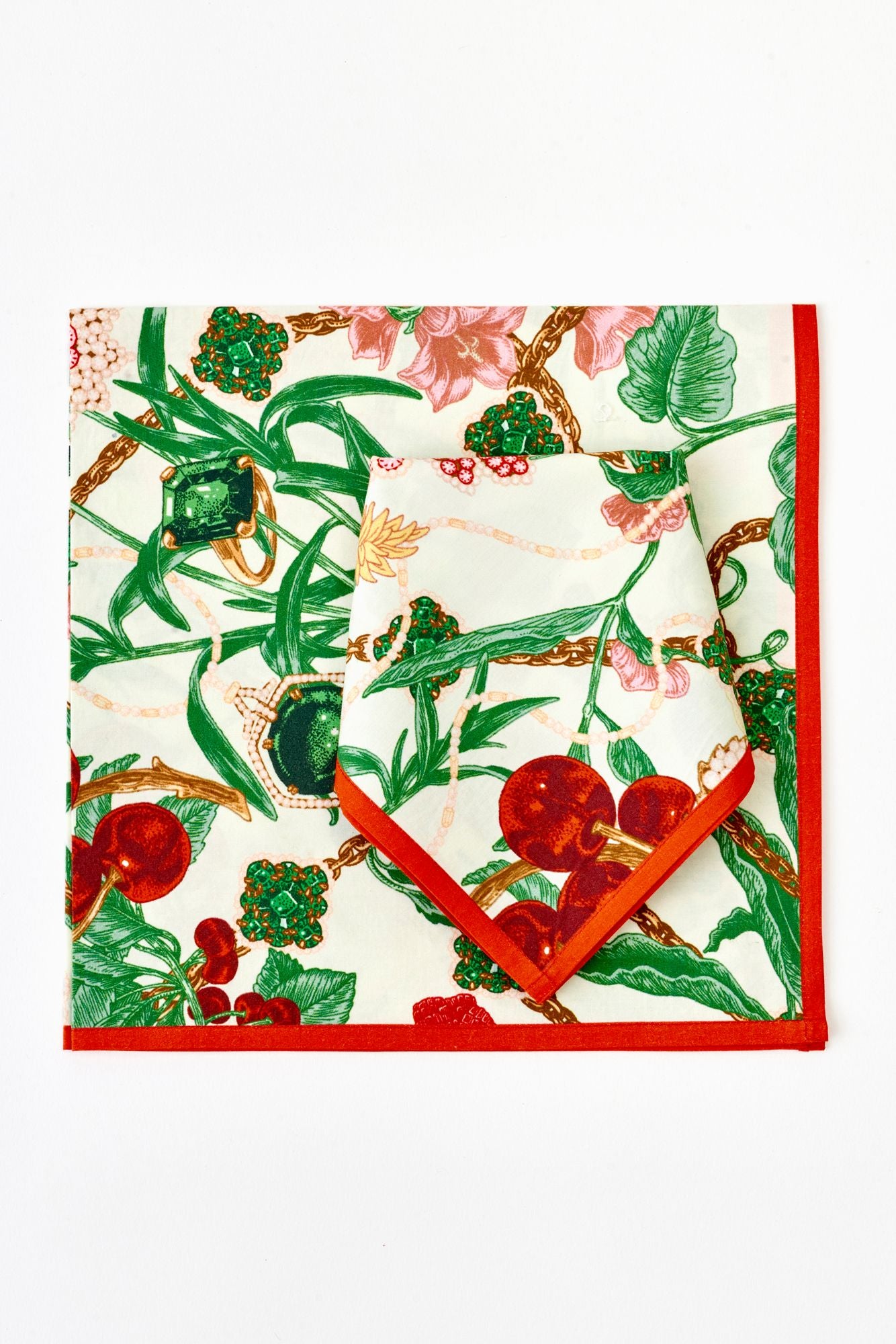 Floral linens with red border on a white background