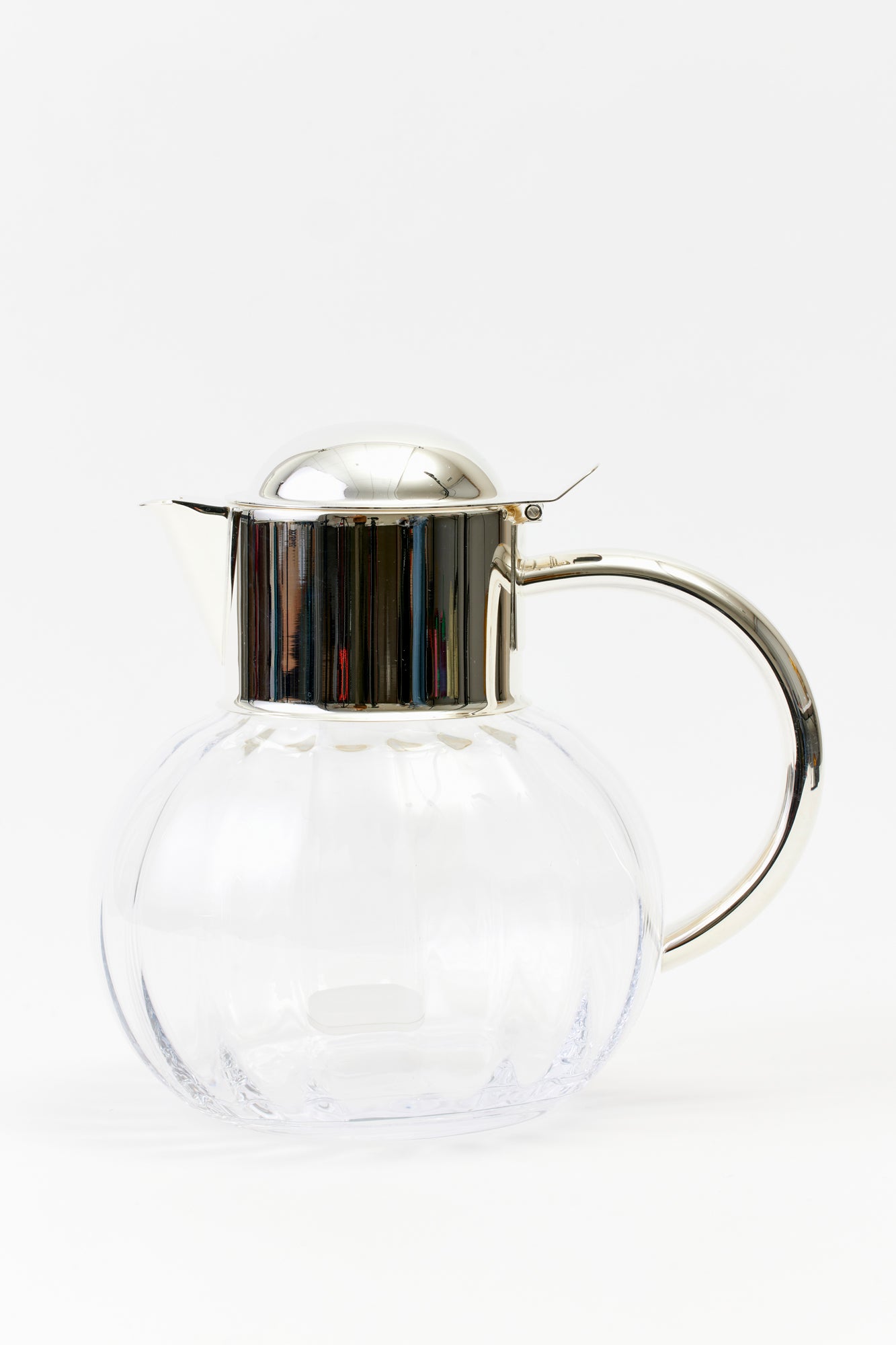 Ice beverage pitcher. Silver-plated top with a crystal body.