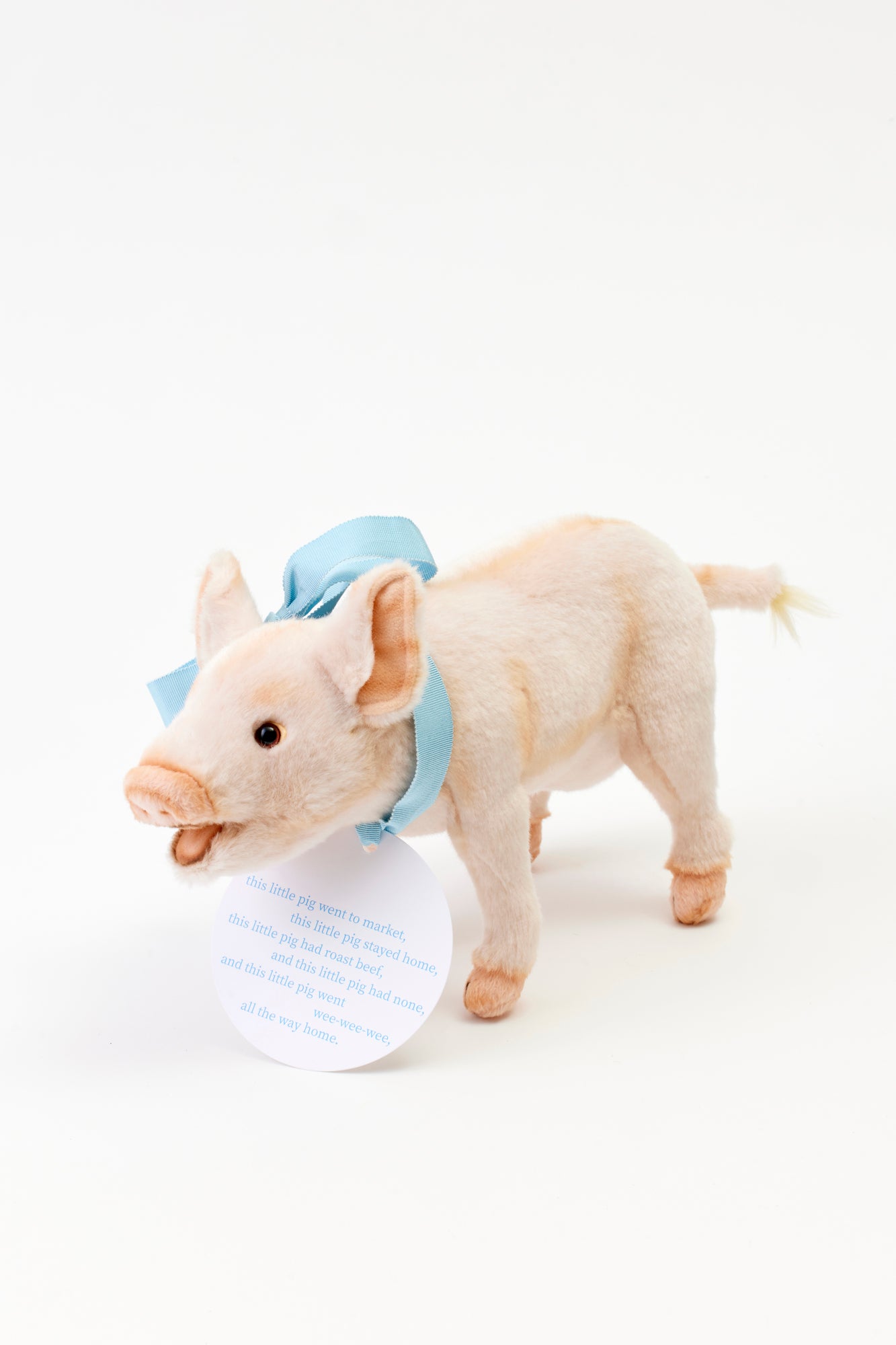 Stuffed pig with blue bow.