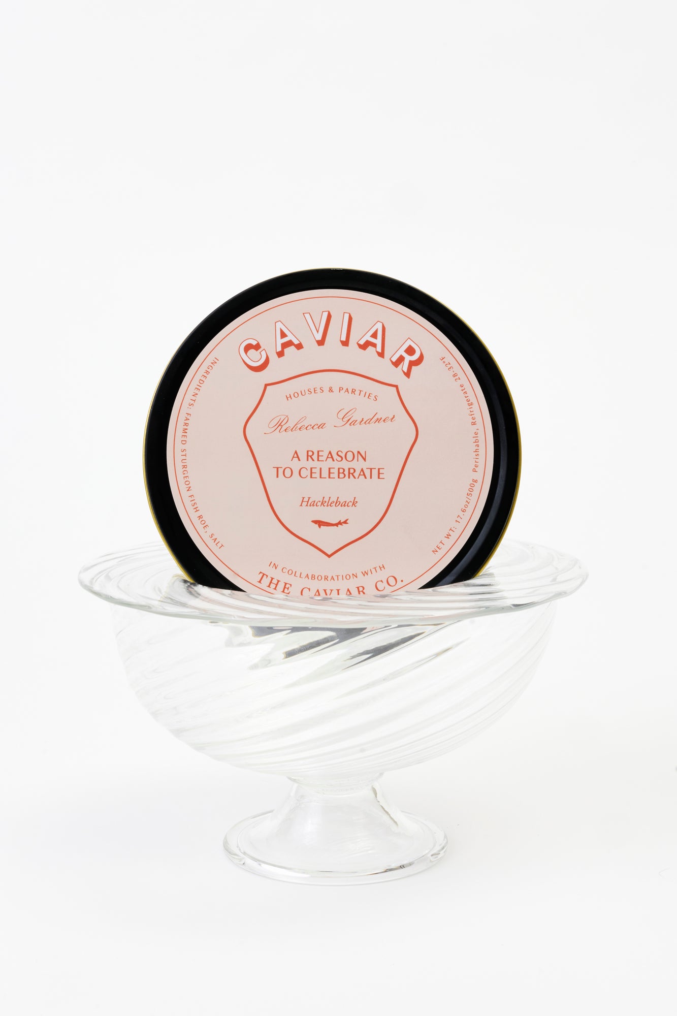 Party-sized artisanal twisted handblown glass caviar service, filled with black caviar and resting on a silver platter with glass caviar spoons.