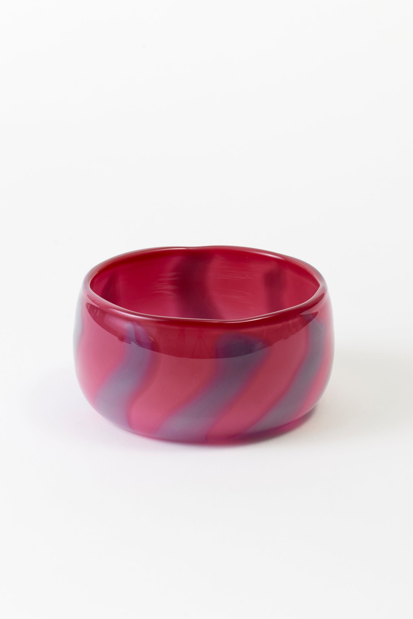 Hand-blown glass candy dishes by Paul Arnhold in pink and purple.