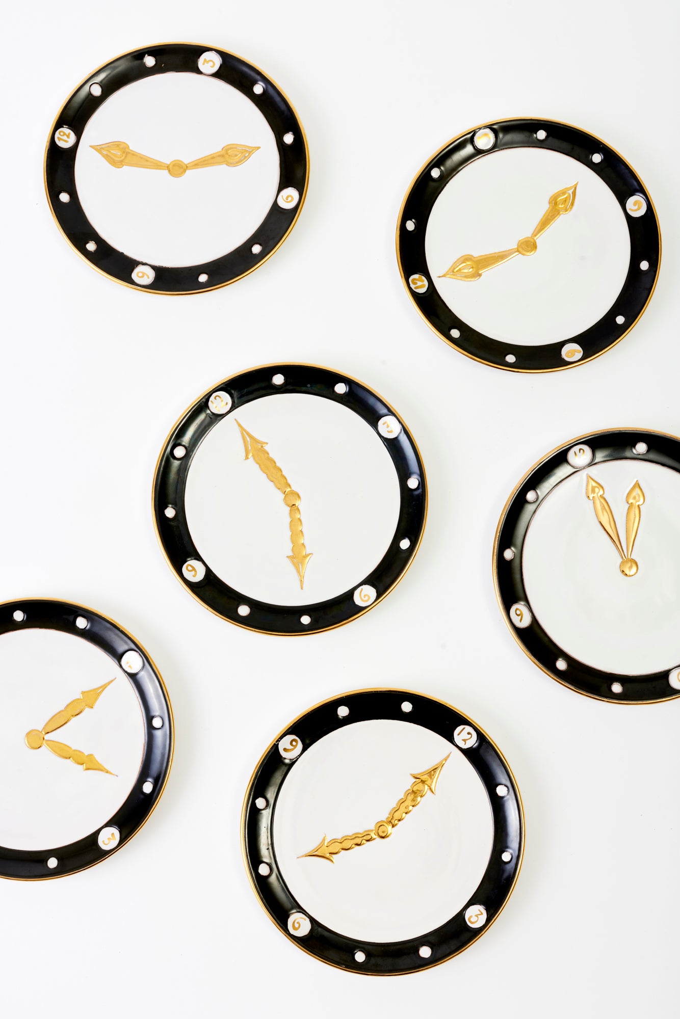 Set of six vintage ceramic clock plates with gold-painted accents.