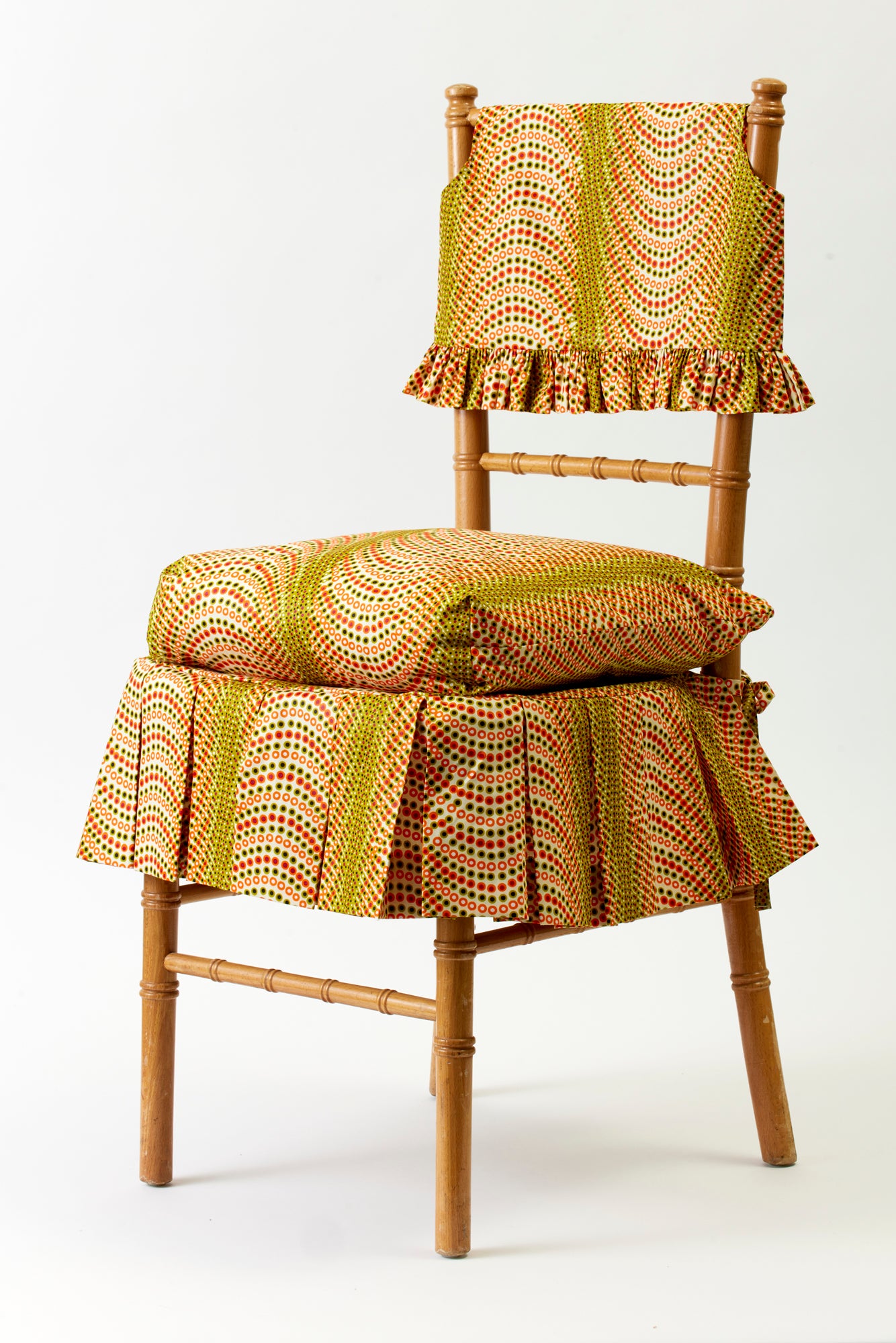 Ruffled slipcover and seat cushion in Ankara cotton.