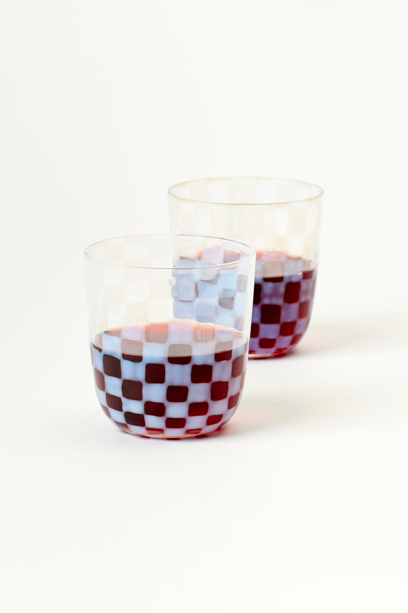 Tumblers with milky checkerboard pattern.
