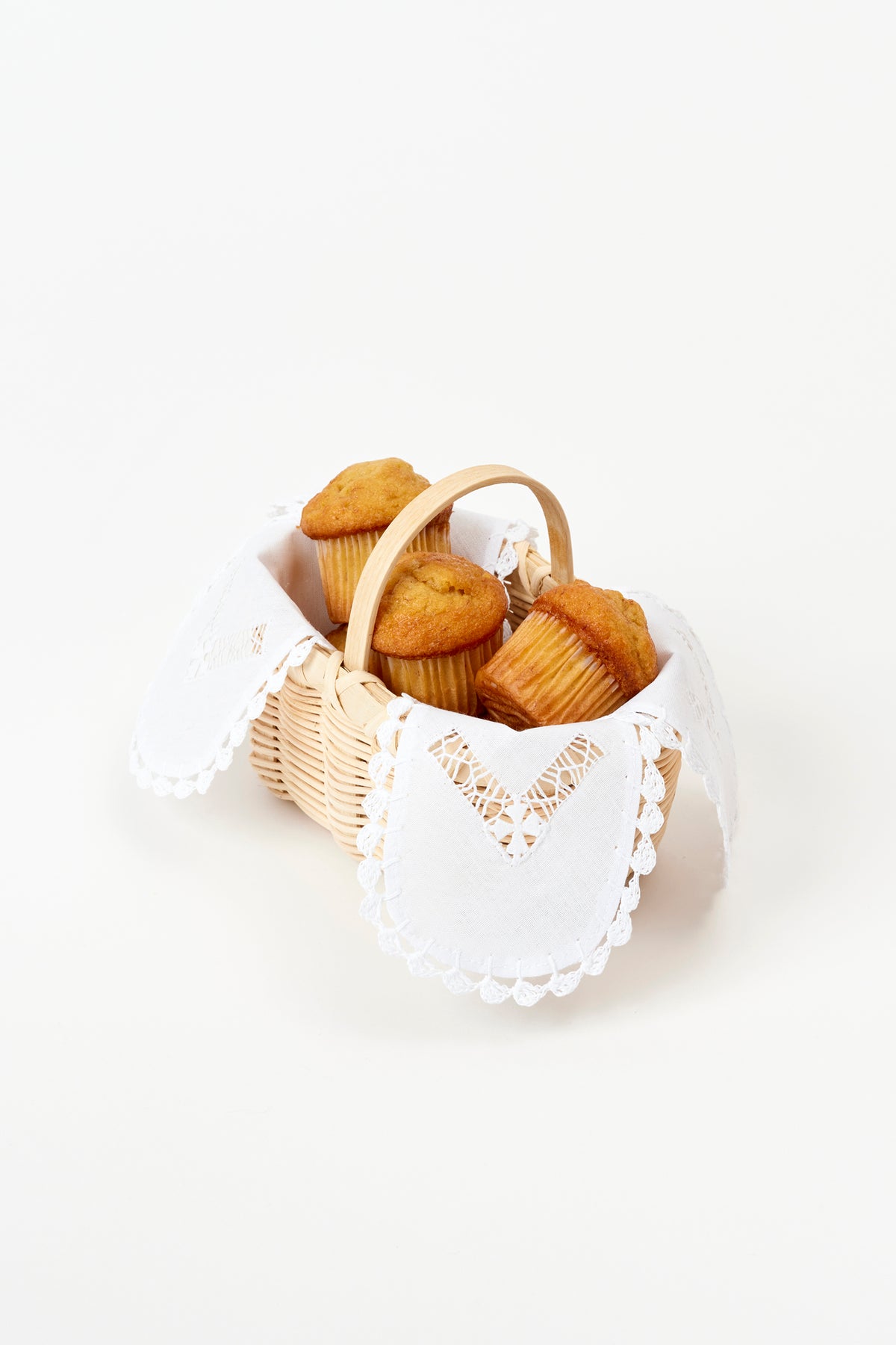 Handwoven basket with a delicate linen liner for serving cheese straws during cocktails.