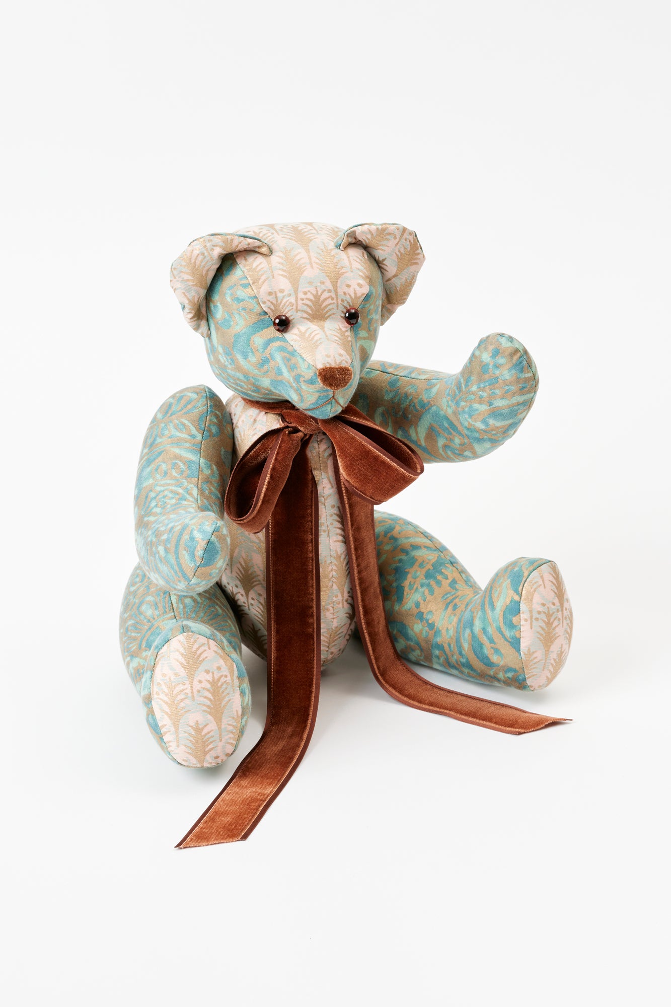 This well-dressed teddy wears Piumette and Canestrelli, two iconic silk prints from Fortuny, a historic fabric house that has handcrafted their textiles since 1922, using ancient methods to create their own pigments and dyes.
