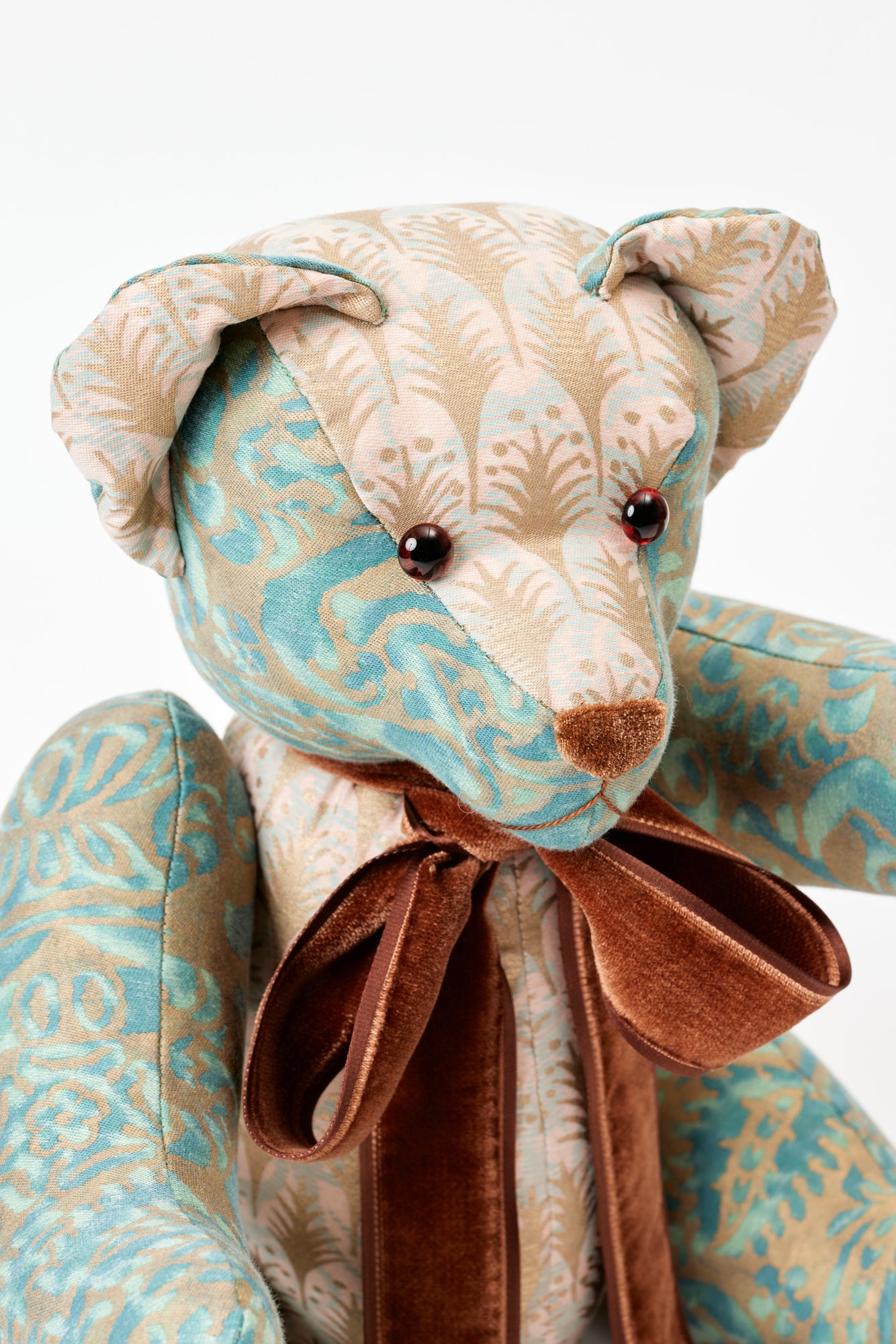 This well-dressed teddy wears Piumette and Canestrelli, two iconic silk prints from Fortuny, a historic fabric house that has handcrafted their textiles since 1922, using ancient methods to create their own pigments and dyes.