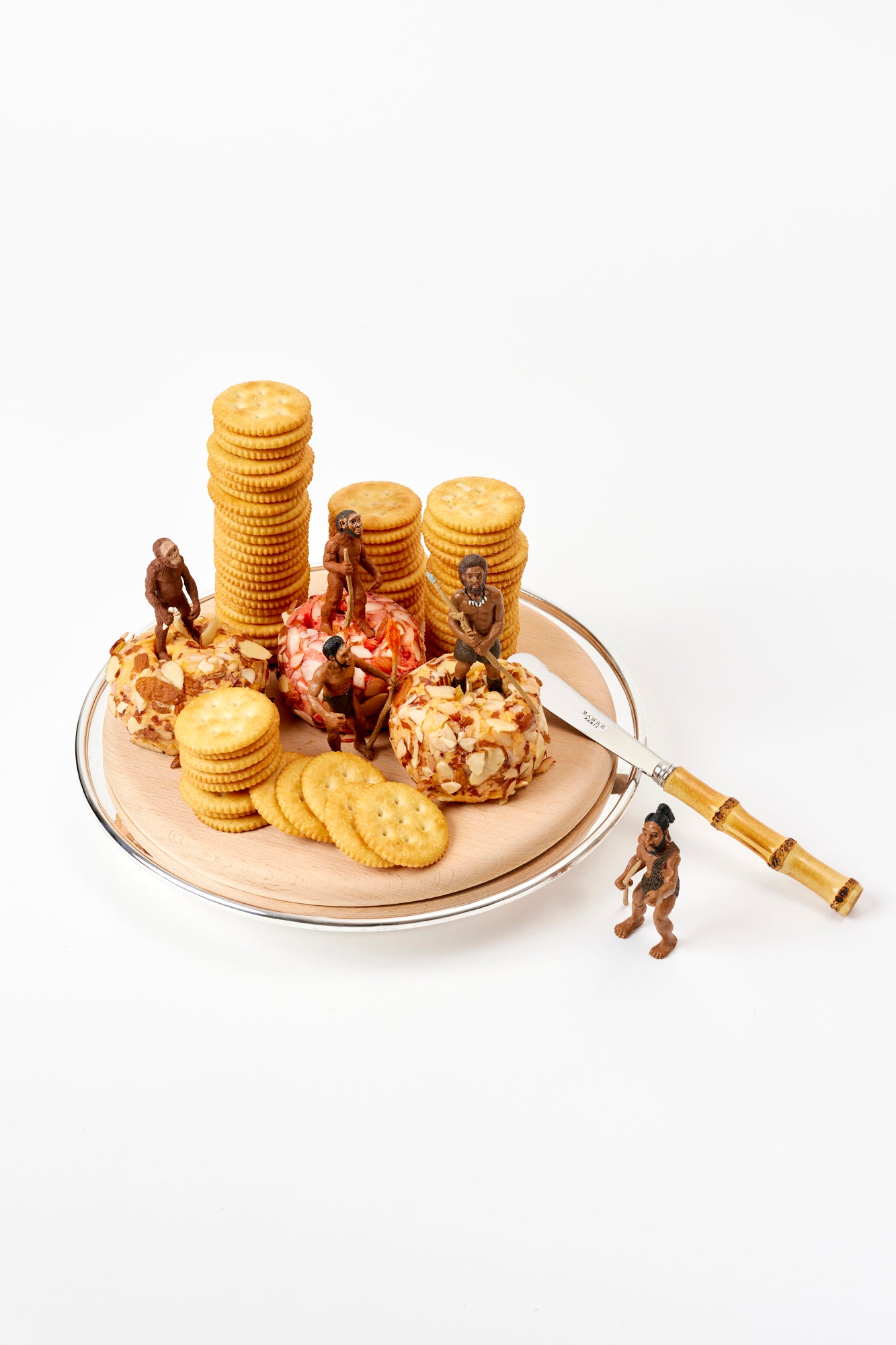 Wood cutting and serving board on a silver-plate stand.