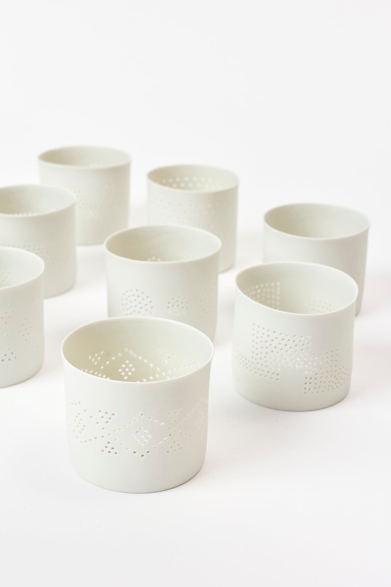 Porcelain bisque votives are sculpted and pierced by hand in France.