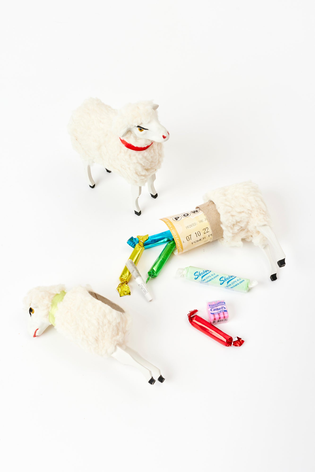 Set of toy sheep that break open and hold sussies such as candy, money, and lottery tickets.
