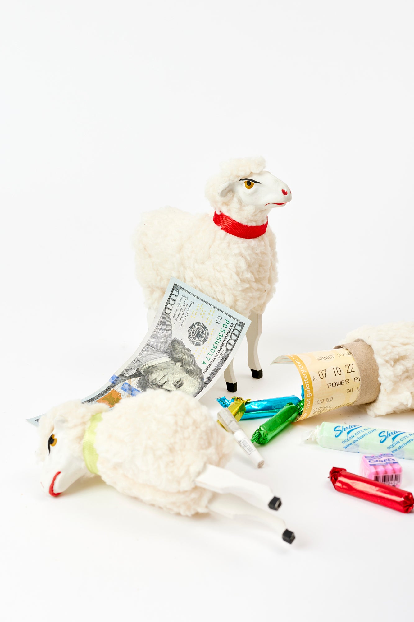 Set of toy sheep that break open and hold sussies such as candy, money, and lottery tickets.