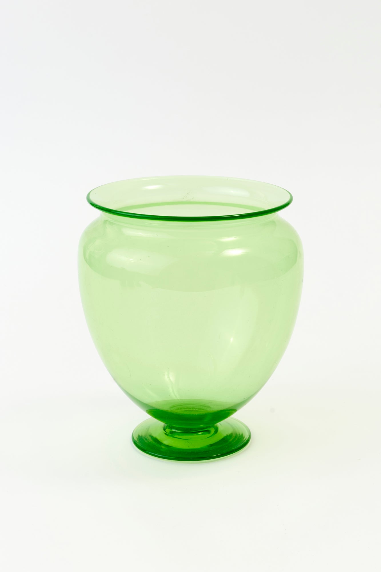 Vintage footed large green transparent vase with an exceptionally wide opening is the perfect shape and size for a large arrangement on an entry table.