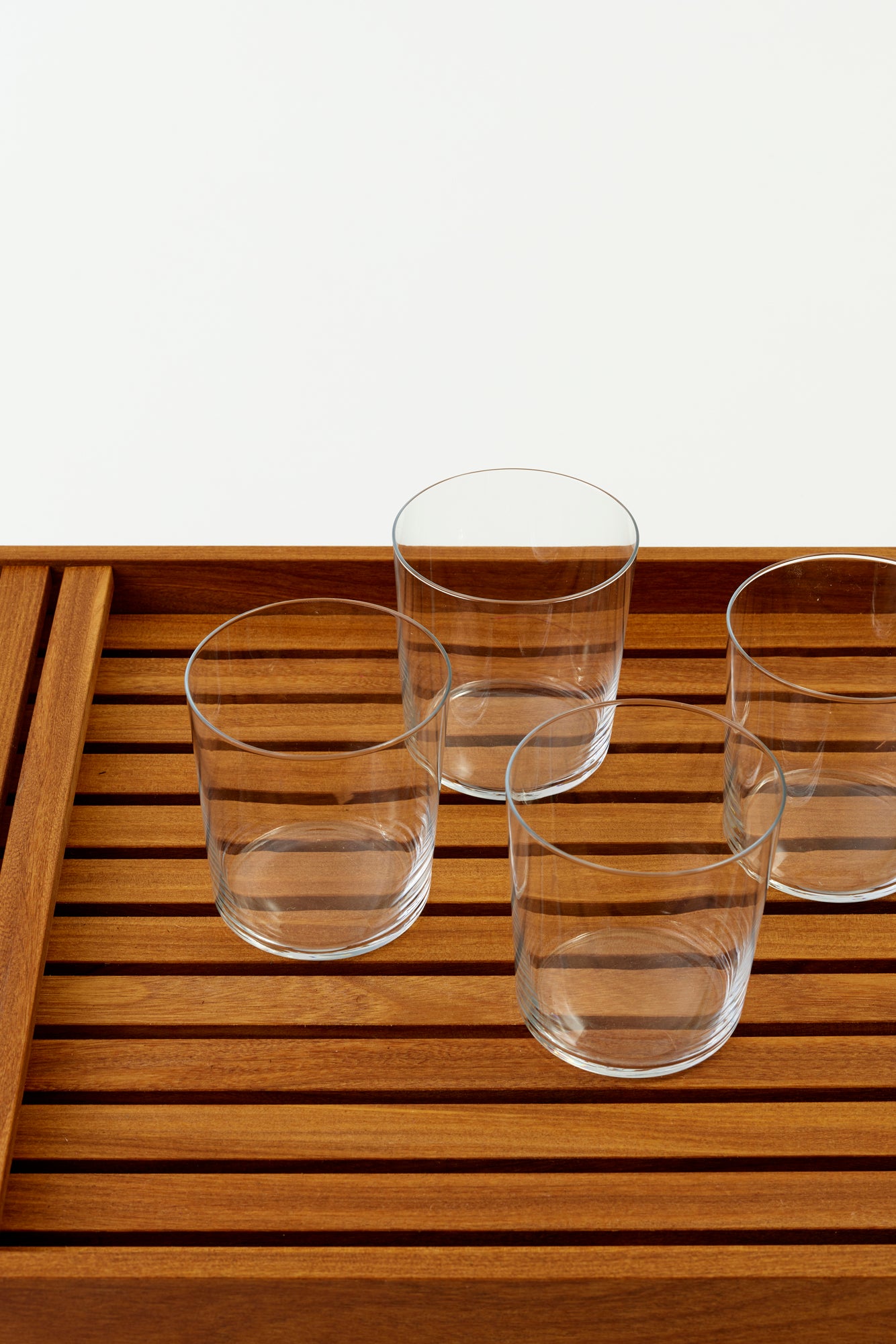 Set of four modern tumblers with fine walls and a stackable design.