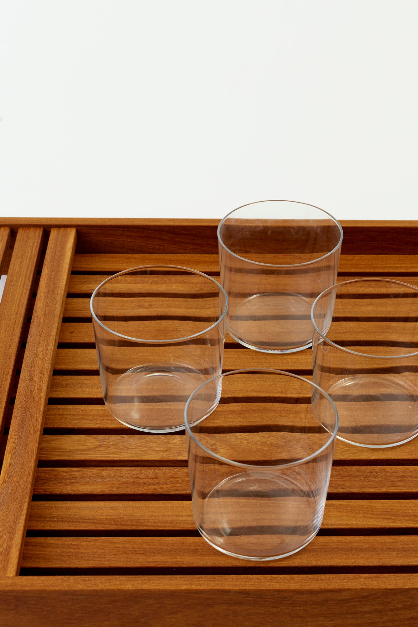 Set of four modern tumblers with fine walls and a stackable design.