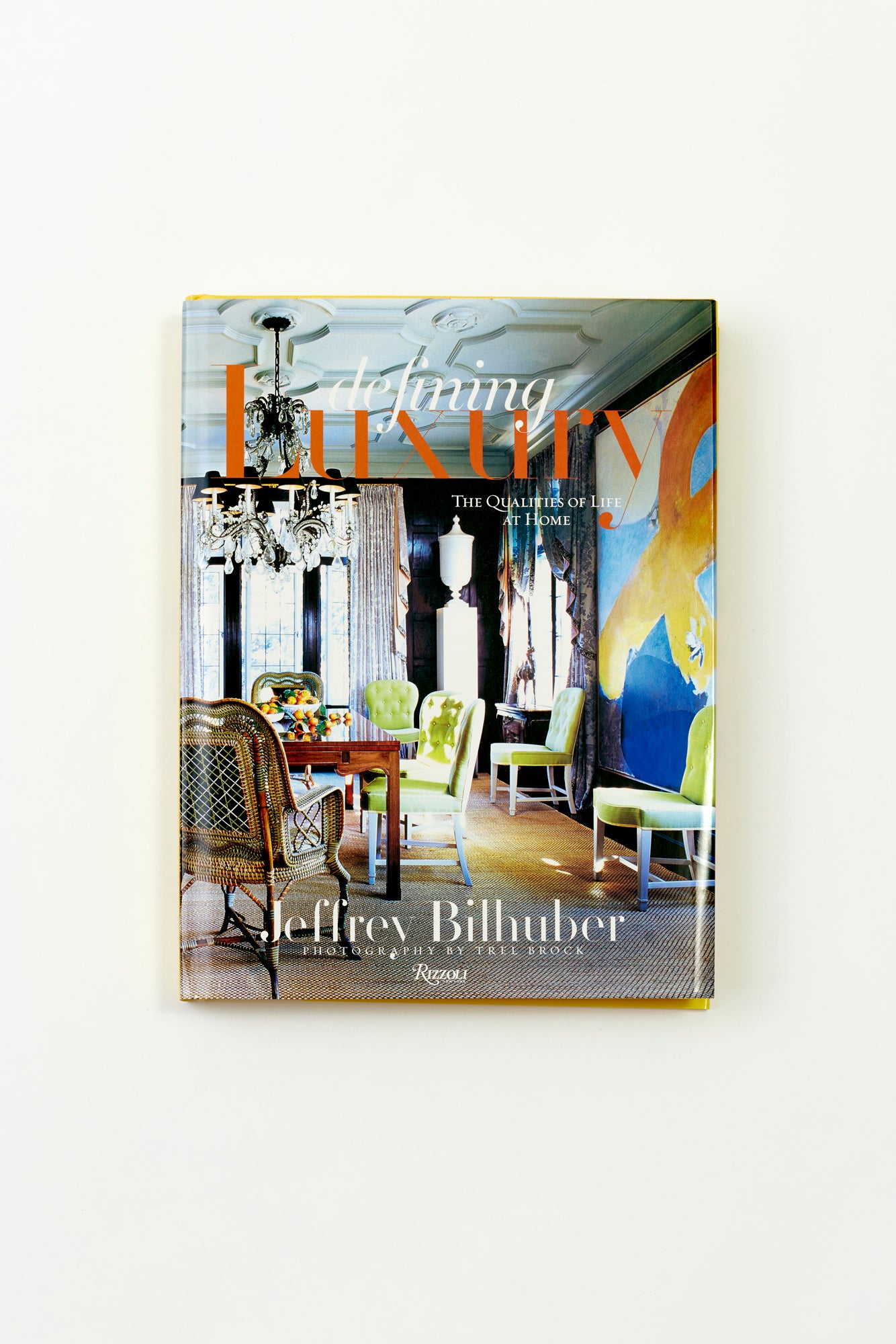 In 'Defining Luxury,' Jeffrey Bilhuber urges readers to embrace and appreciate luxury in its many forms, whether it be the comfort of a perfectly tufted reading chair, the elegance of heirloom vases cradling fresh garden roses, or the magic of a dazzling chandelier casting enchanting light.