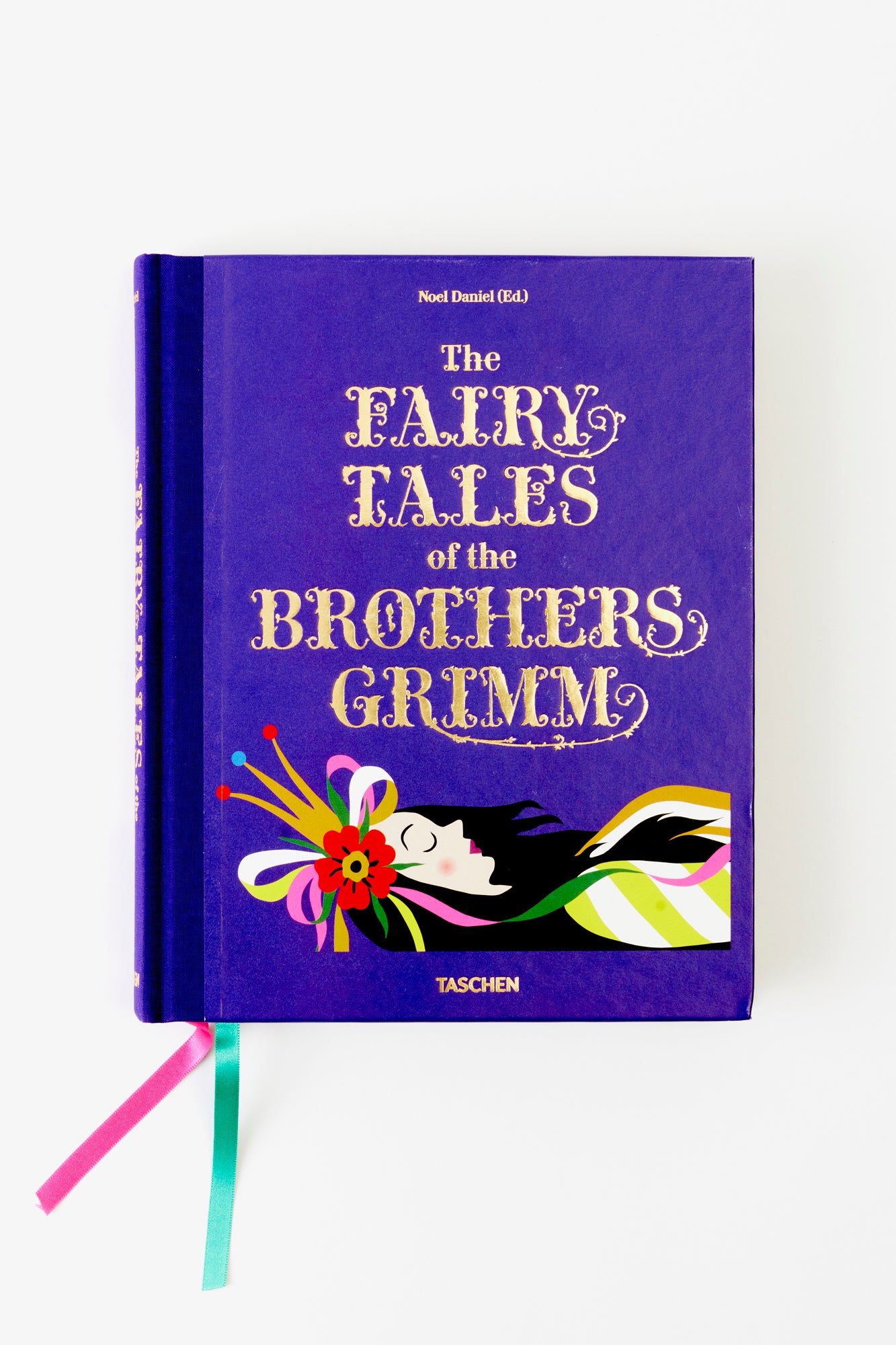 The bold purple cover of The Fairy Tales of the Brothers Grimm by TASCHEN, featuring gold embossed lettering and a whimsical illustration of Sleeping Beauty. This collector's edition is a timeless compilation of classic fairy tales with rich artwork.