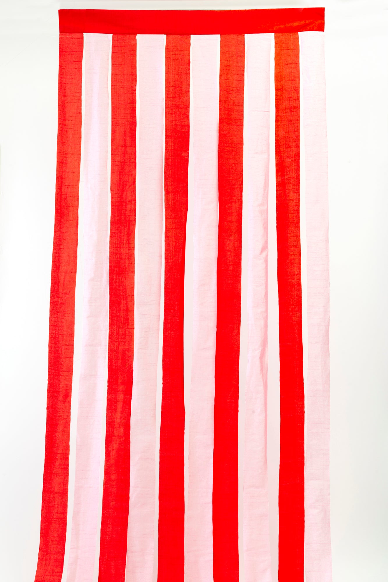 Festive pink and red striped fabric drapes, perfect for adding a bold and playful touch to your Christmas party decor. With a vibrant color palette reminiscent of holiday cheer, these eye-catching curtains set the stage for a chic, modern celebration.