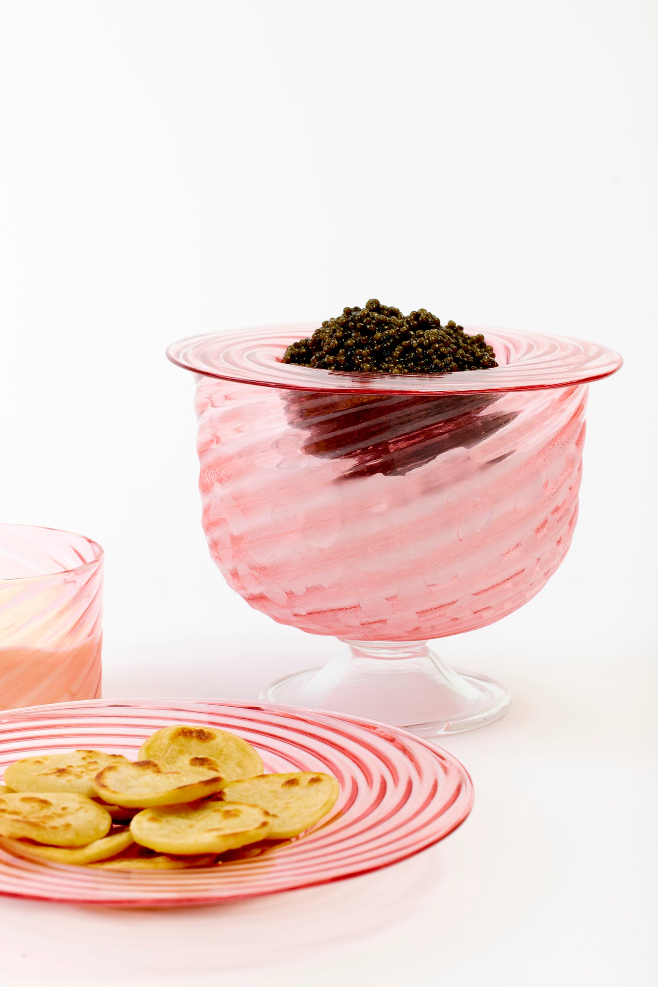 Artisanal twisted glass caviar service in blush, handblown by Tracy Glover in her Rhode Island studio.
