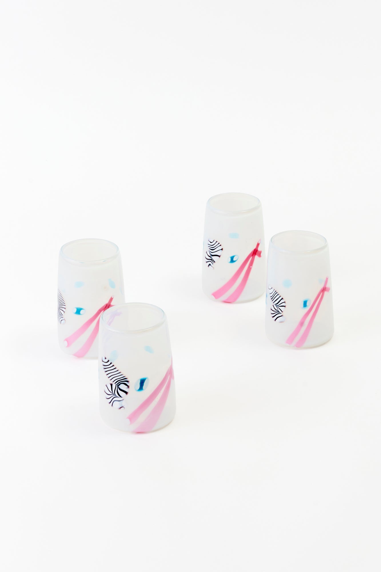Post-modern tumblers with pink lines, blue, black and white designs. Excellent vintage condition.