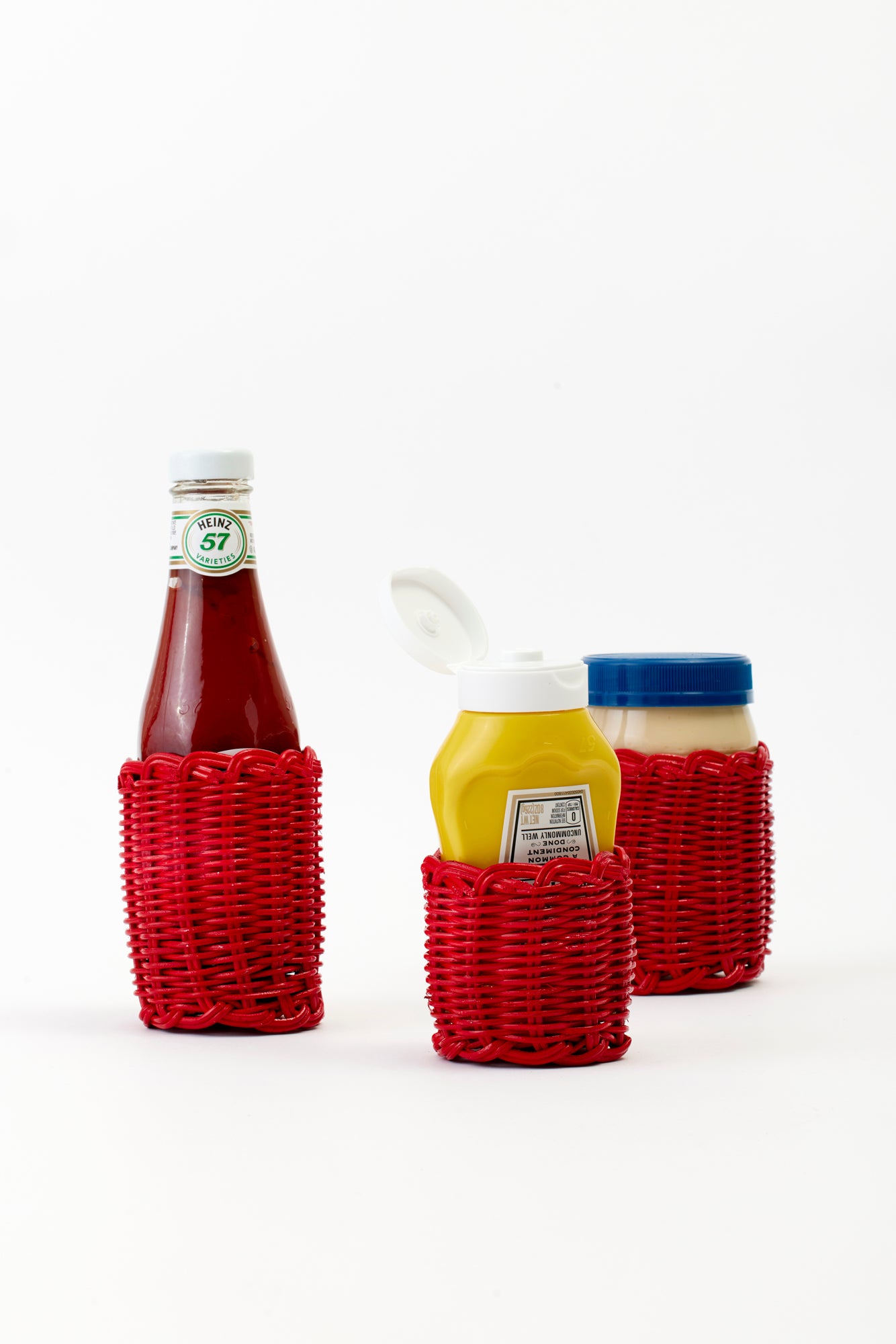 Red wicker condiment covers.