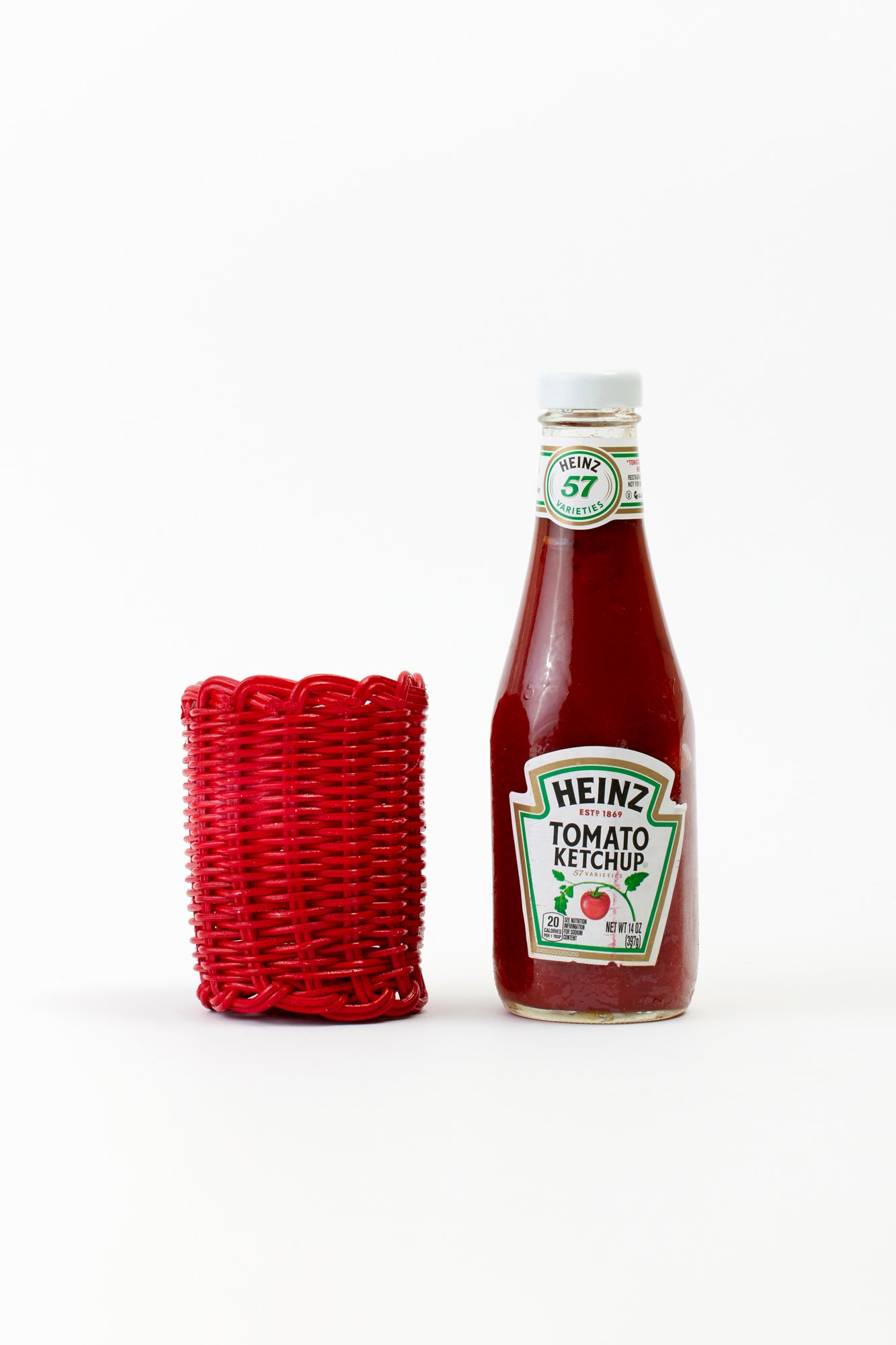 Red wicker condiment cover for ketchup.