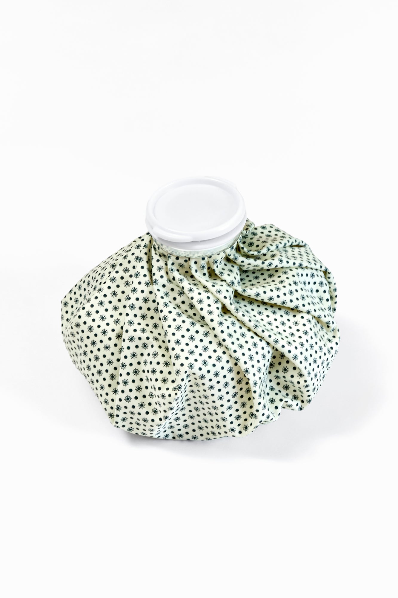 Vintage polka dot ice pack cover on a white background.
