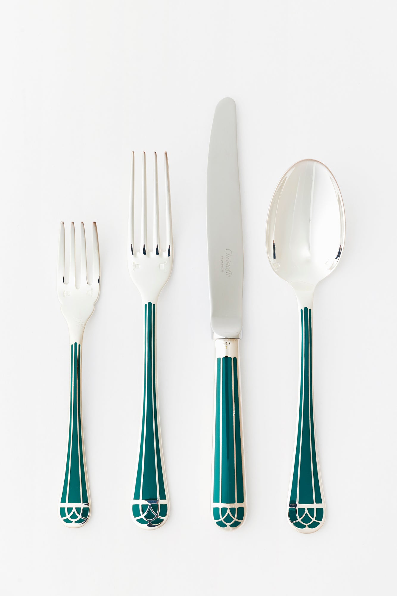 Set of 4 flatware, including a salad fork, dinner fork, dinner knife, and spoon. Silver with blue cloisonné detailing on each handle.