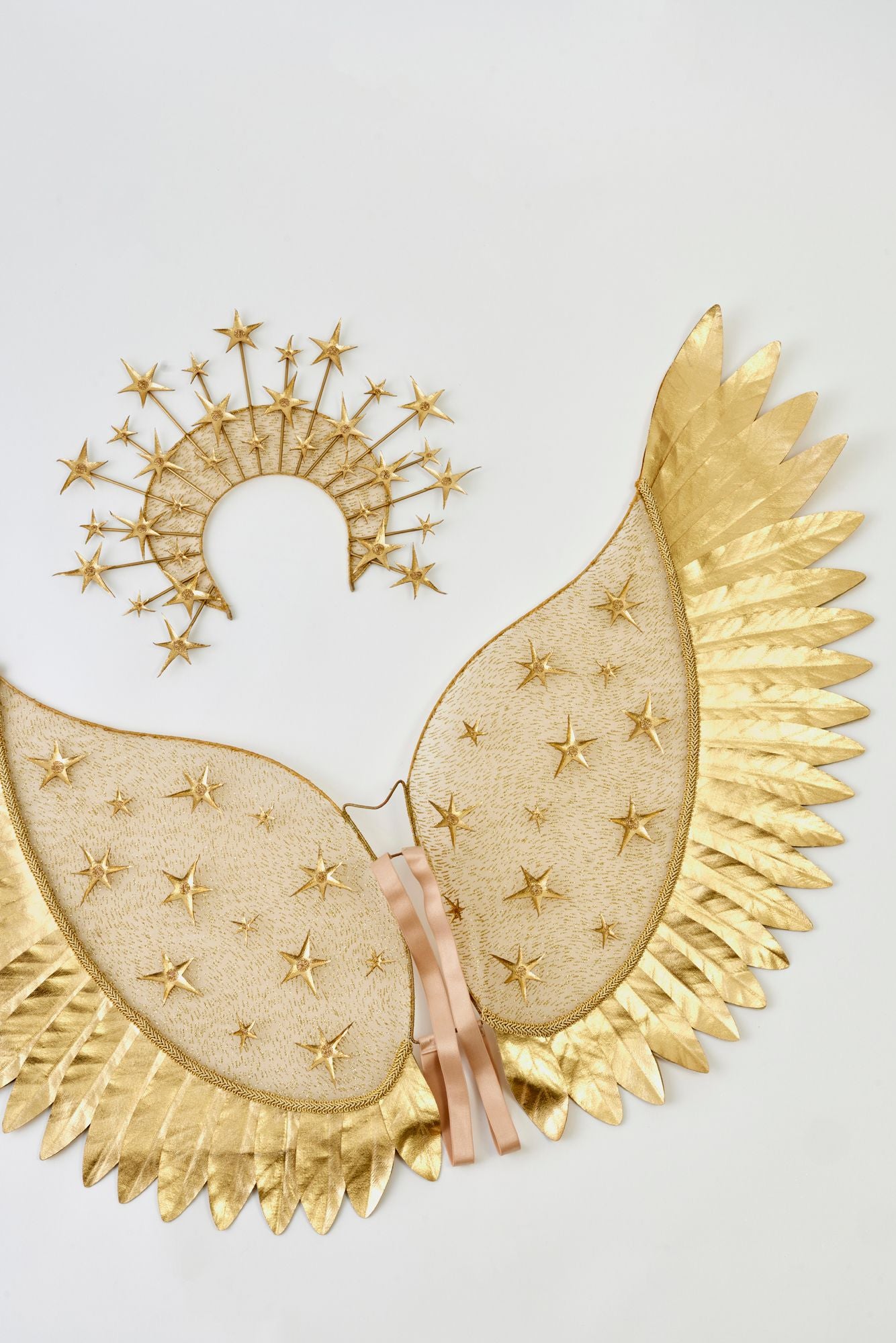 Decorative gold angel wings and halo white background