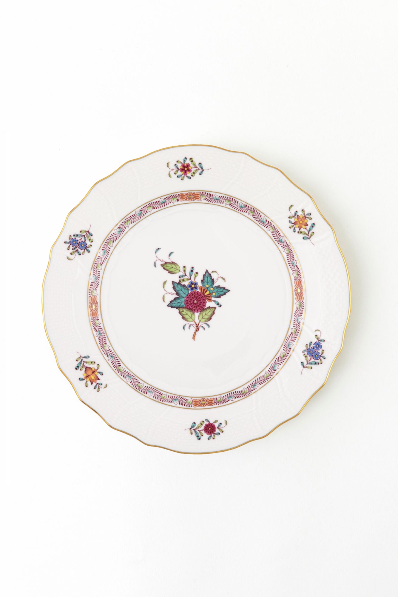 Decorative Herend plate with floral patterns on a white background