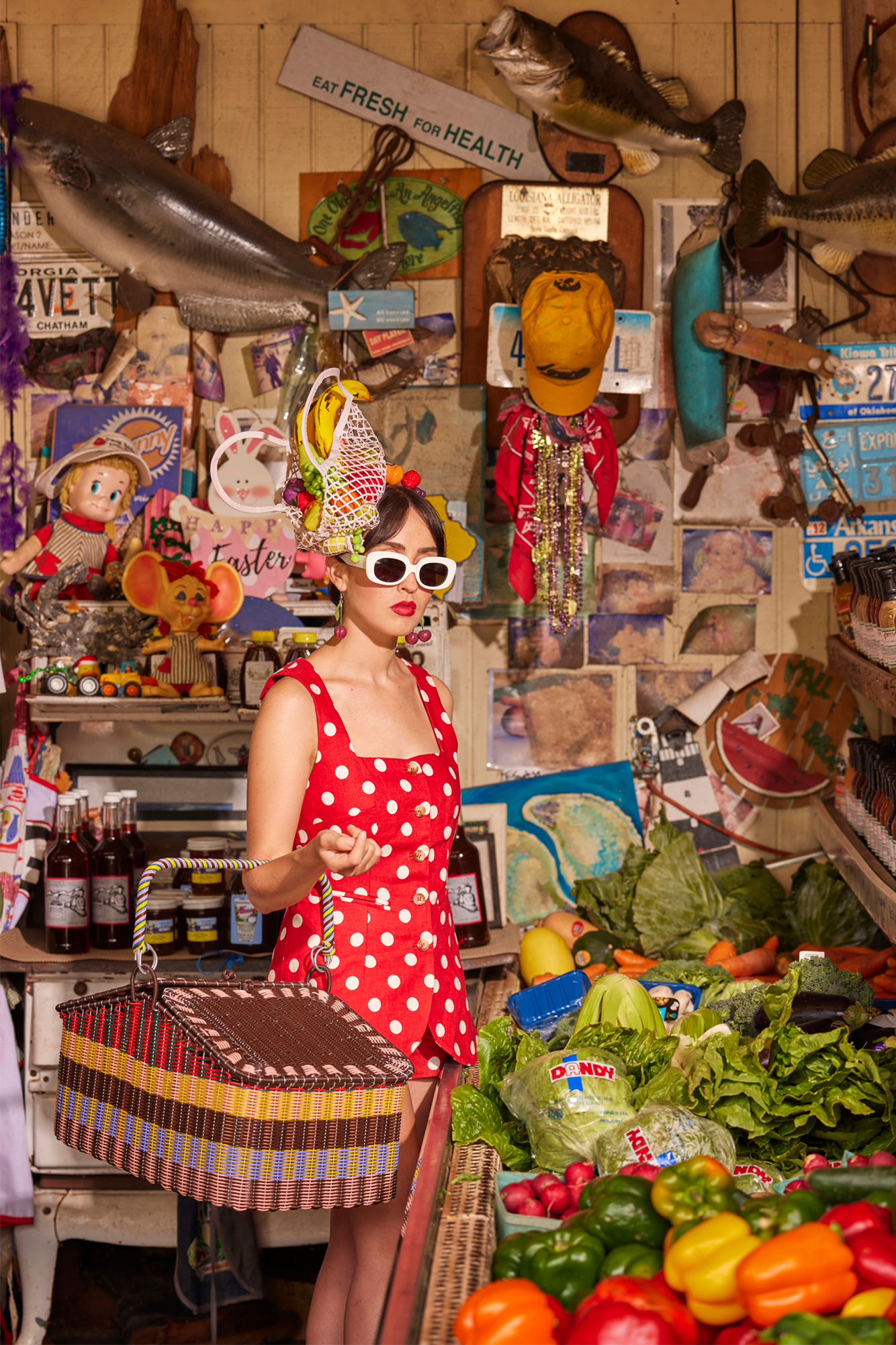 Woman at a fruit market with a fruit bag hat, and a woven picnic basket.