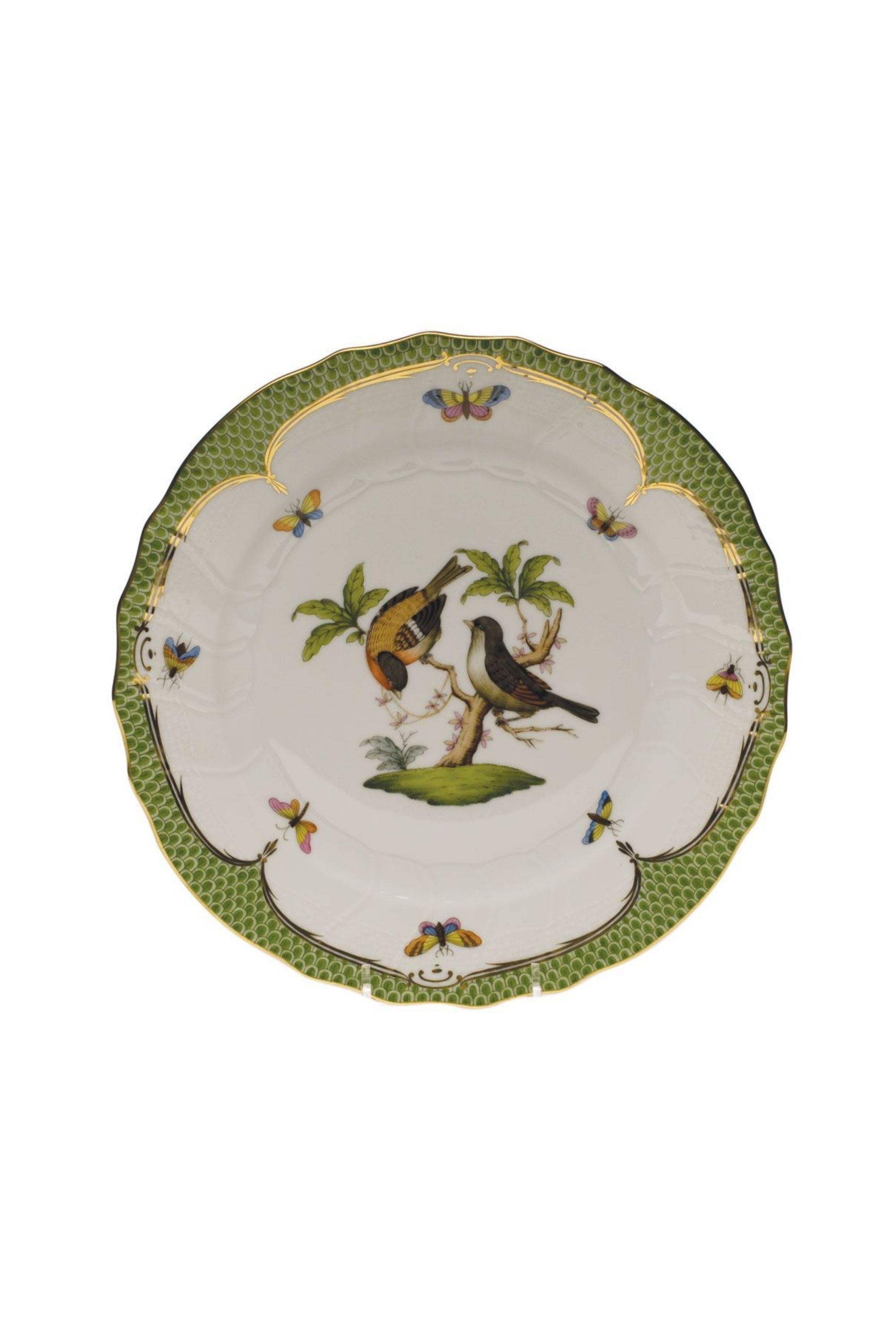 Green porcelain dinnerware. Rothschild Bird is a lush design featuring the highly recognizable bird motif framed by tiny hand-painted fish scales outlined in 24-karat gold.