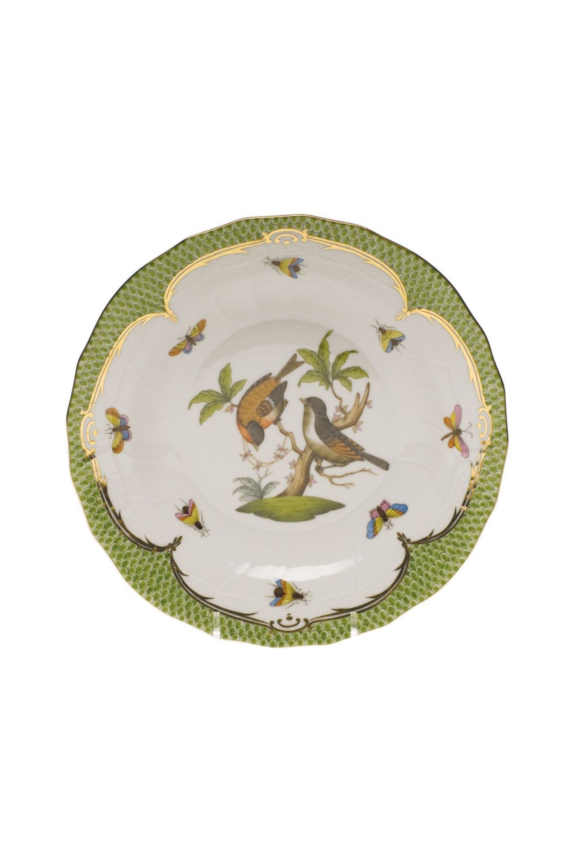 Green porcelain dinnerware. Rothschild Bird is a lush design featuring the highly recognizable bird motif framed by tiny hand-painted fish scales outlined in 24-karat gold.