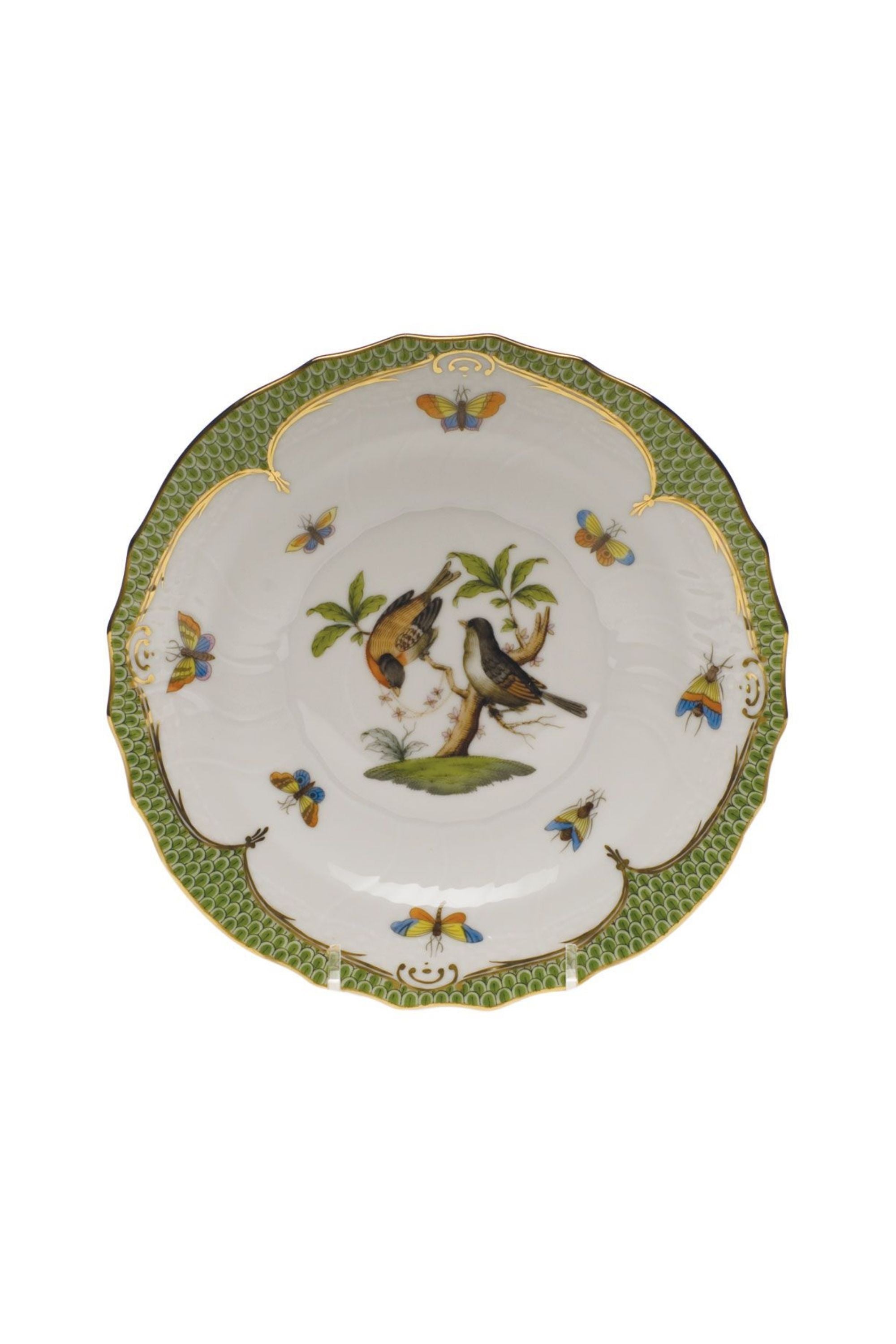 Green porcelain dinnerware. Rothschild Bird is a lush design featuring the highly recognizable bird motif framed by tiny hand-painted fish scales outlined in 24-karat gold.