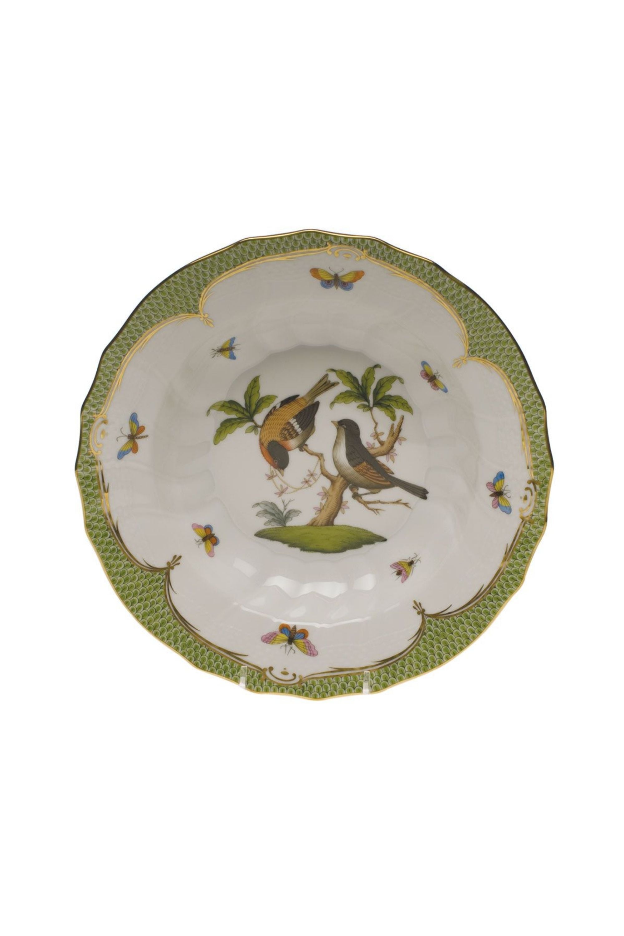 Green porcelain dinnerware. Rothschild Bird is a lush design featuring the highly recognizable bird motif framed by tiny hand-painted fish scales outlined in 24-karat gold.