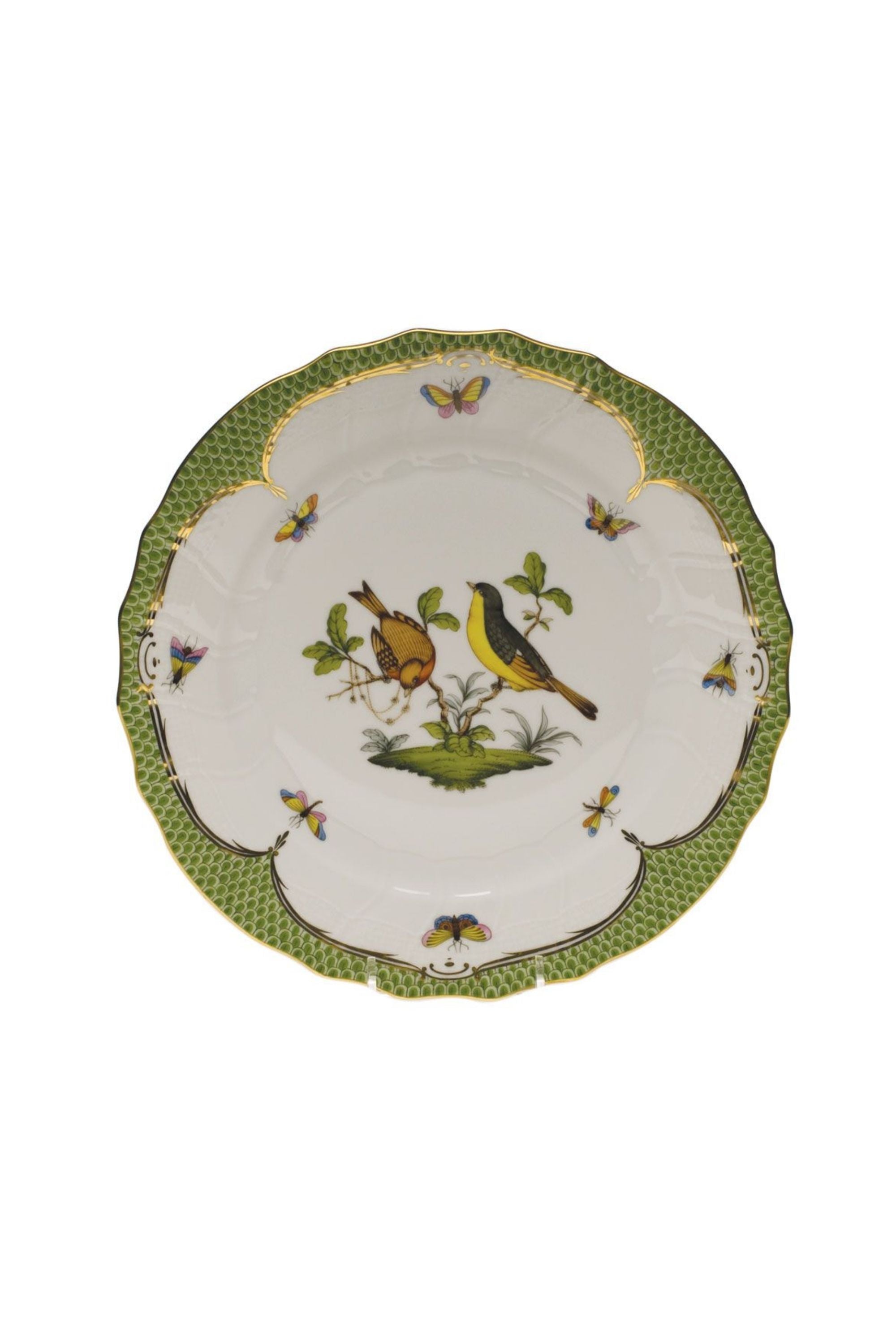Green porcelain dinnerware. Rothschild Bird is a lush design featuring the highly recognizable bird motif framed by tiny hand-painted fish scales outlined in 24-karat gold.