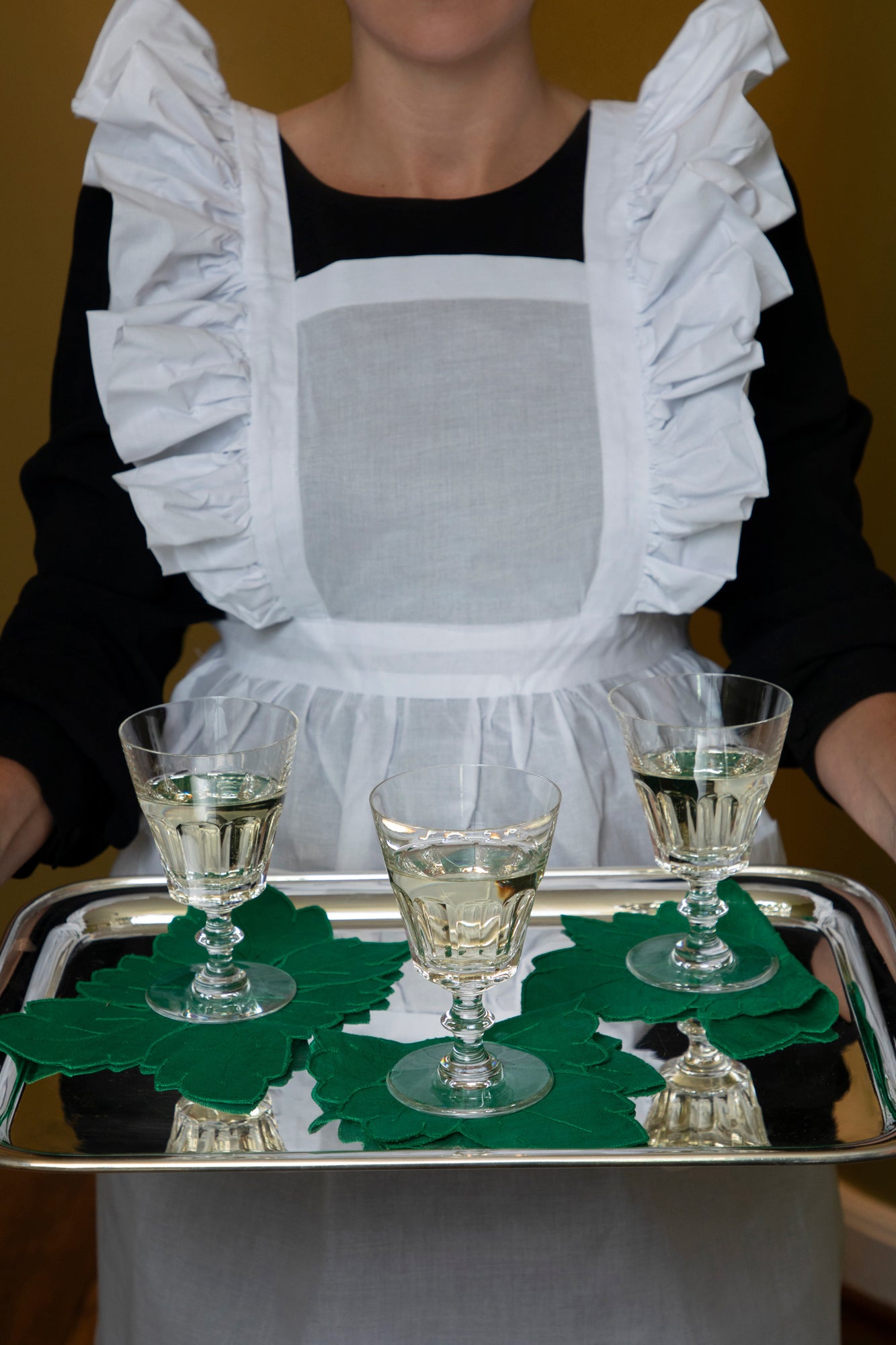 Charming ruffled aprons in white cotton organdy.