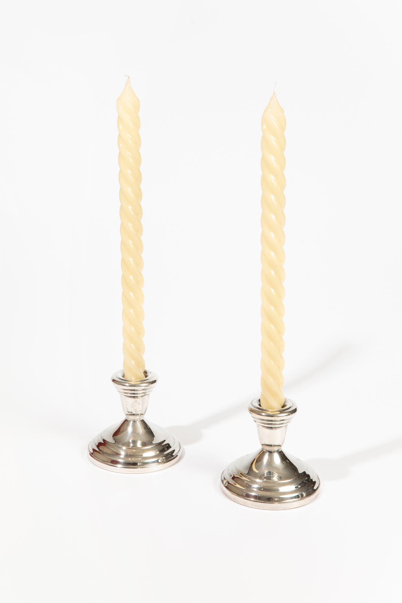 Twisted wax candle tapers in classic ivory.