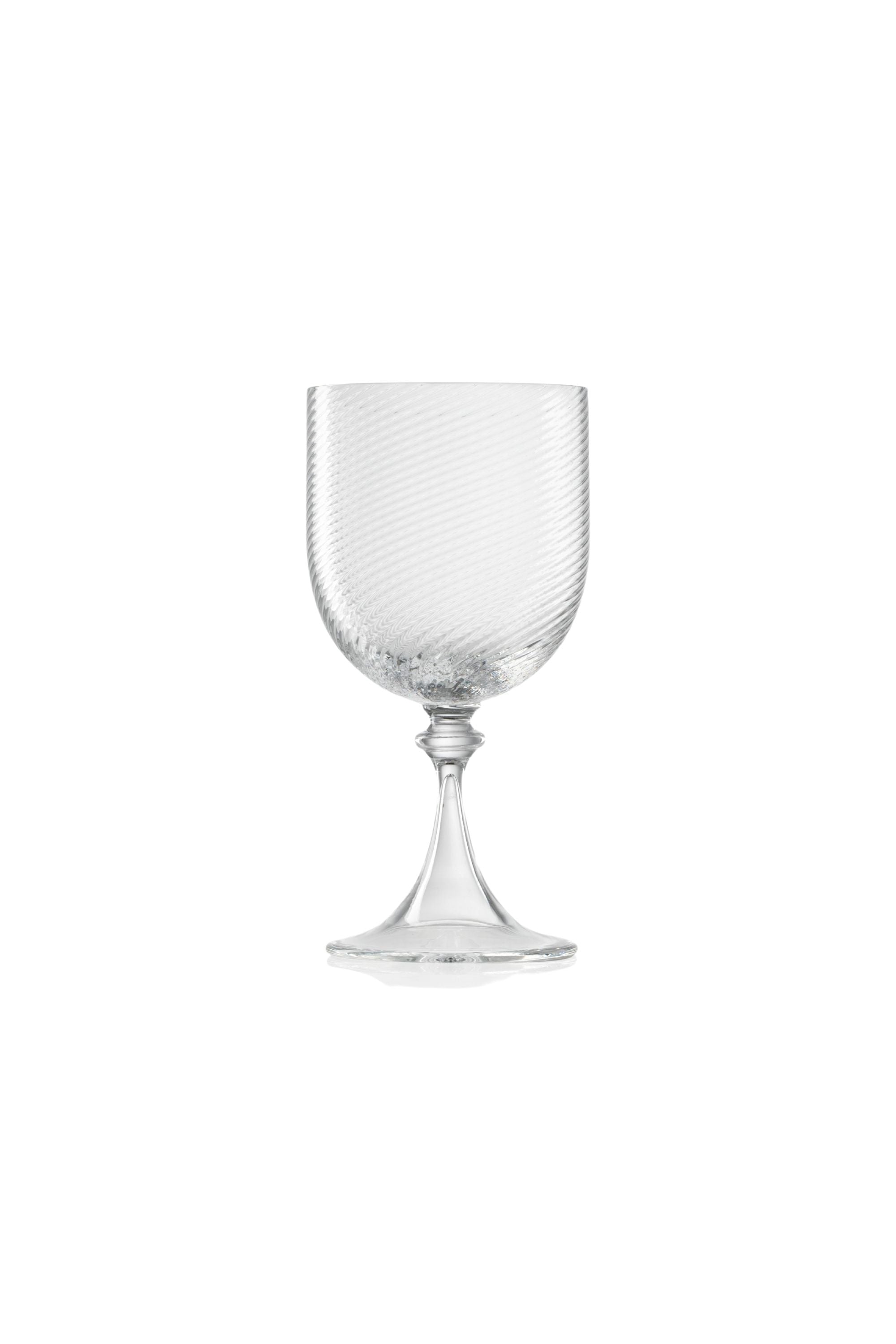 Handblown on the Venetian Island of Murano, these glasses feature a handmade stem and twisted texture in Clear. The elegant form made in glass makes this a versatile chameleon to be used with stoneware or china.