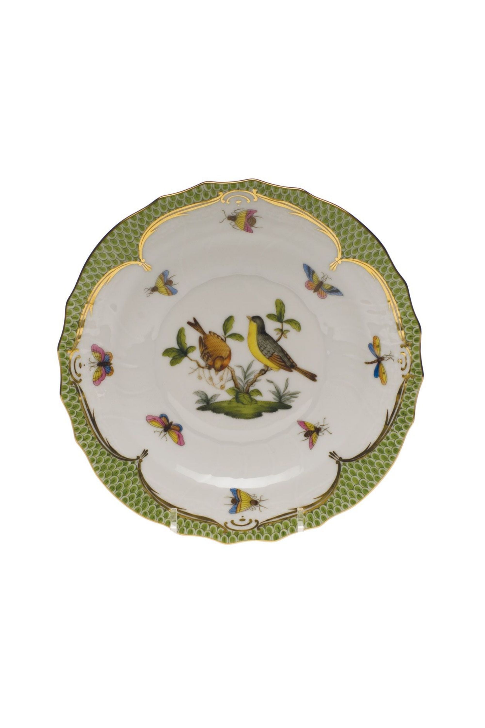Green porcelain dinnerware. Rothschild Bird is a lush design featuring the highly recognizable bird motif framed by tiny hand-painted fish scales outlined in 24-karat gold.