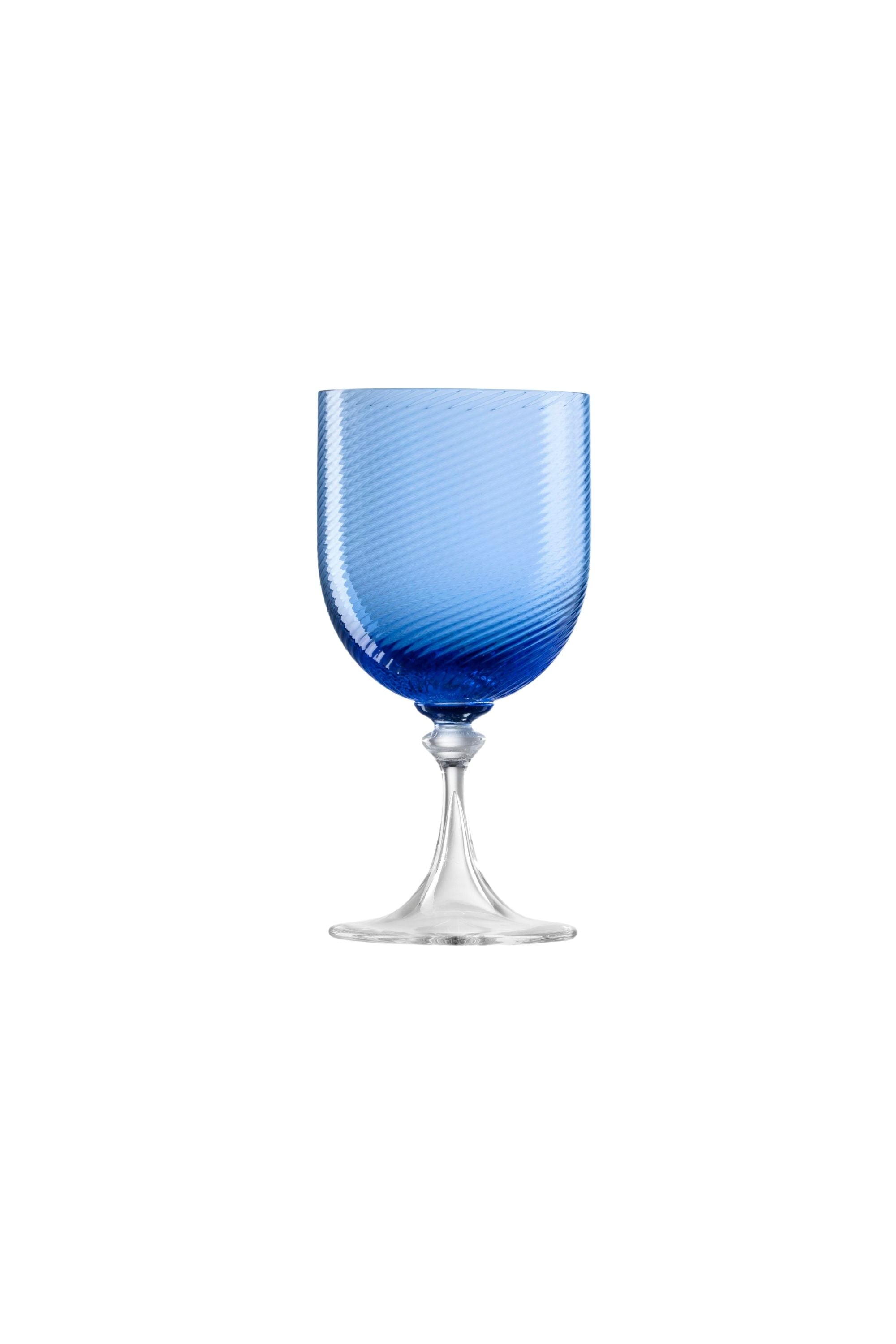 Handblown on the Venetian Island of Murano, these glasses feature a handmade stem and twisted texture in Blue. The elegant form made in glass makes this a versatile chameleon to be used with stoneware or china.